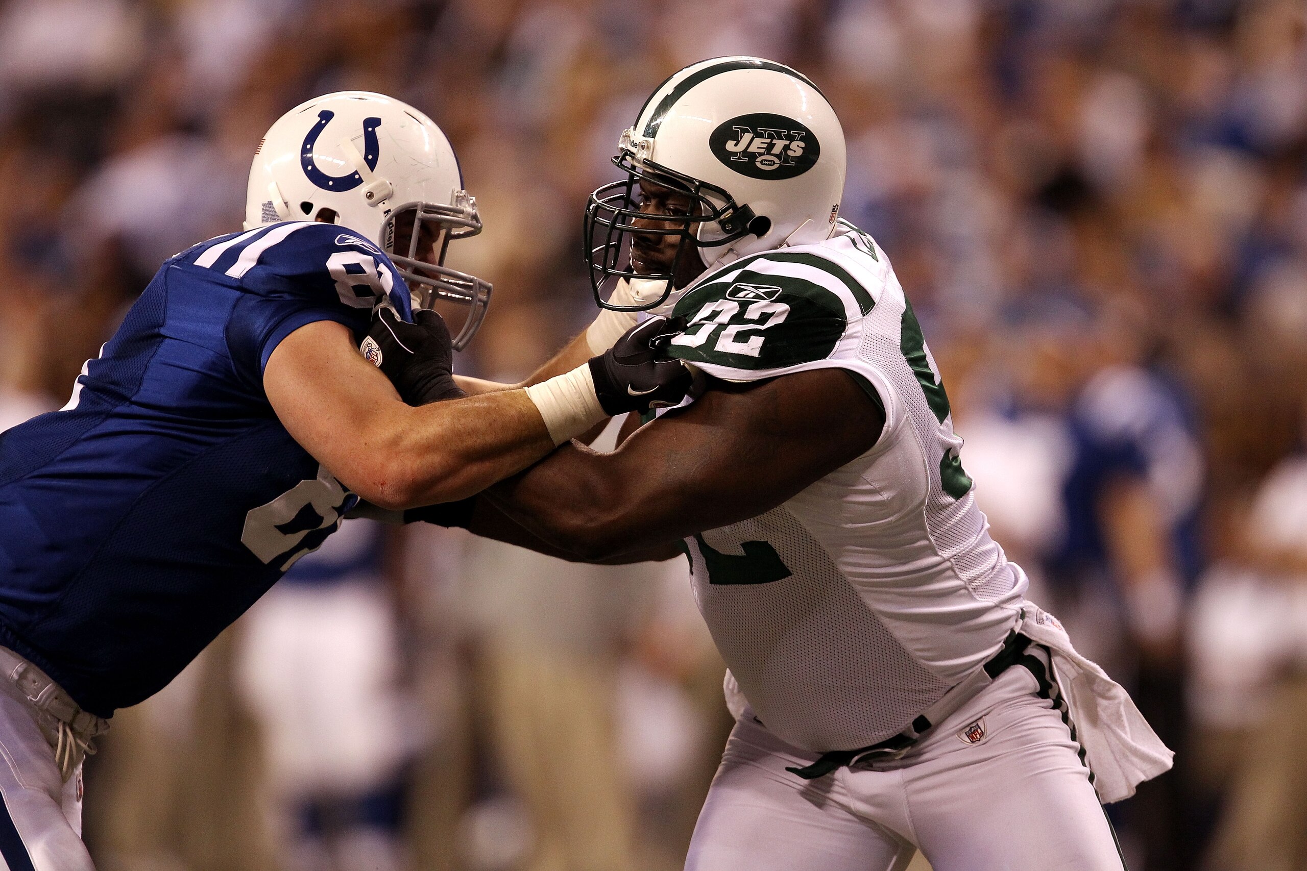 INDIANAPOLIS, IN - JANUARY 08:  Defensive end Shaun Ellis #92 of the New York Jets rushes the passer against Bobby Eldridge #81 of the Indianapolis Colts during their 2011 AFC wild card playoff game at Lucas Oil Stadium on January 8, 2011 in Indianapolis,