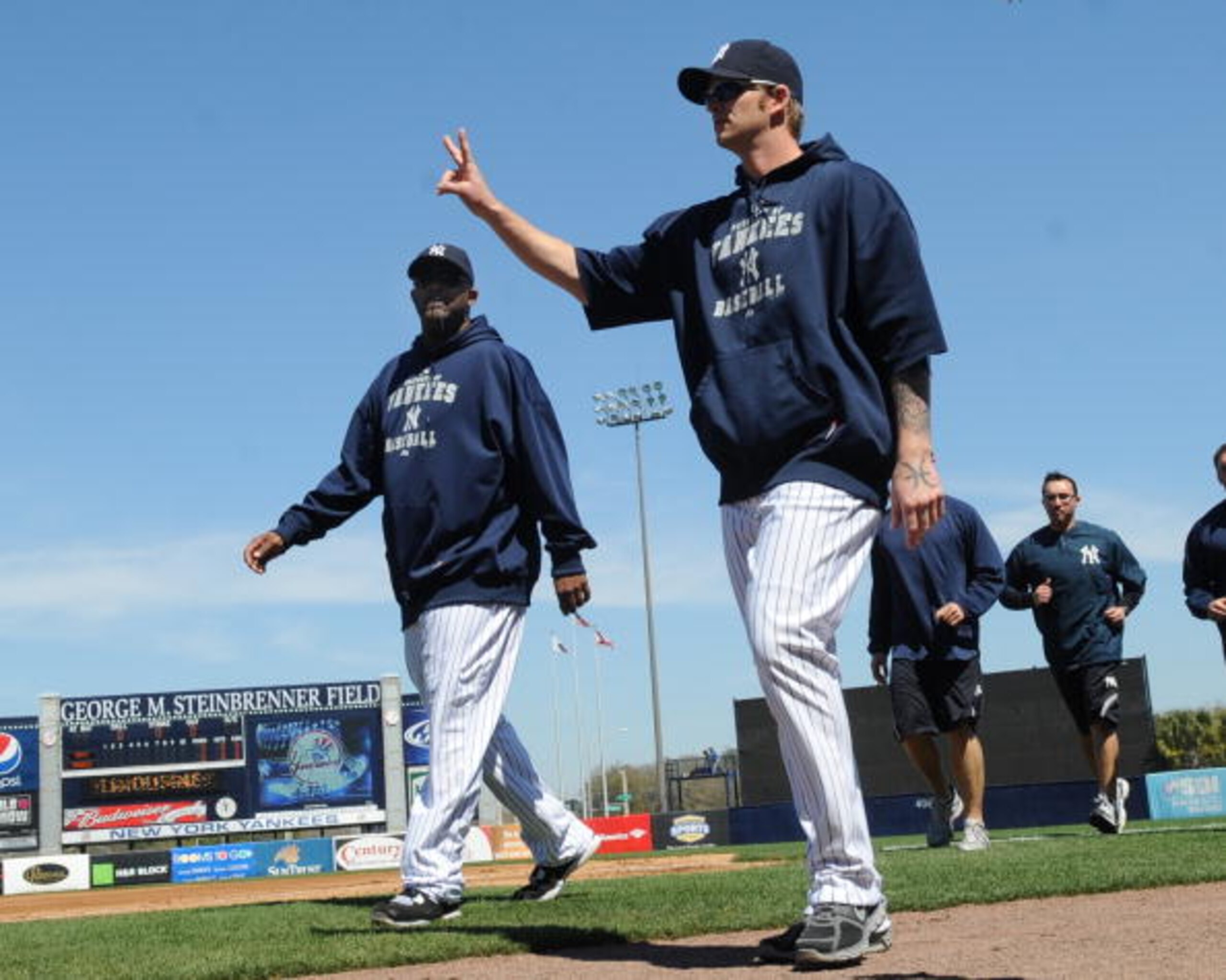 TAMPA, FL - MARCH 5: Pitchers A. J. Burnett #34 and CC Sabathia  #52 of the New York Yankees walk to the dugout before play  against the Tampa Bay Rays March 5, 2010 at the George M. Steinbrenner  Field in Tampa, Florida. (Photo by Al Messerschmidt/Getty