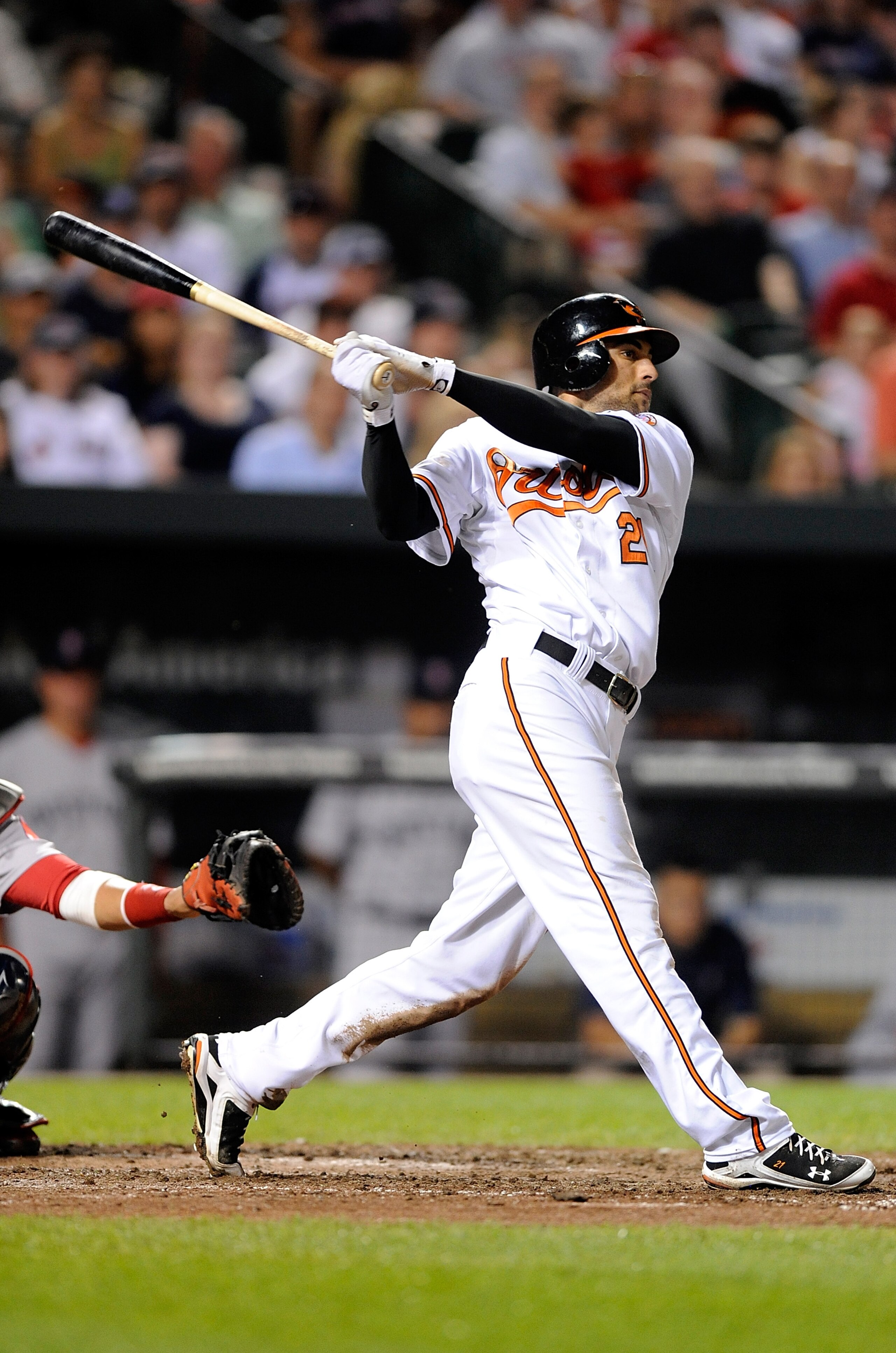 BALTIMORE - MAY 01:  Nick Markakis #21 of the Baltimore Orioles hits a home run in the sixth inning against the Boston Red Sox at Camden Yards on May 1, 2010 in Baltimore, Maryland.  (Photo by Greg Fiume/Getty Images)