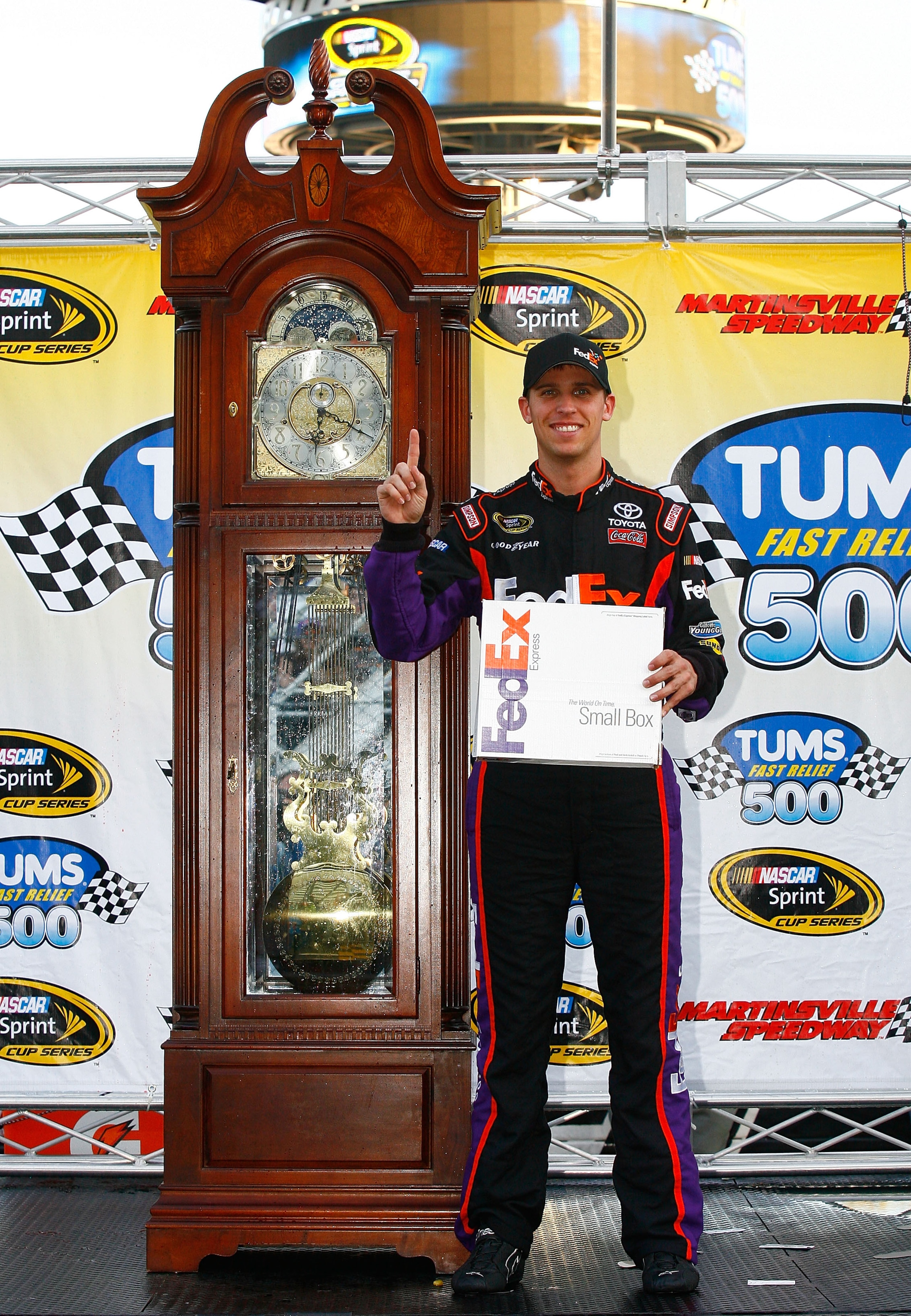 MARTINSVILLE, VA - OCTOBER 24:  Denny Hamlin, driver of the #11 FedEx Express Toyota, poses in Victory Lane after winning the NASCAR Sprint Cup Series TUMS Fast Relief 500 at Martinsville Speedway on October 24, 2010 in Martinsville, Virginia.  (Photo by