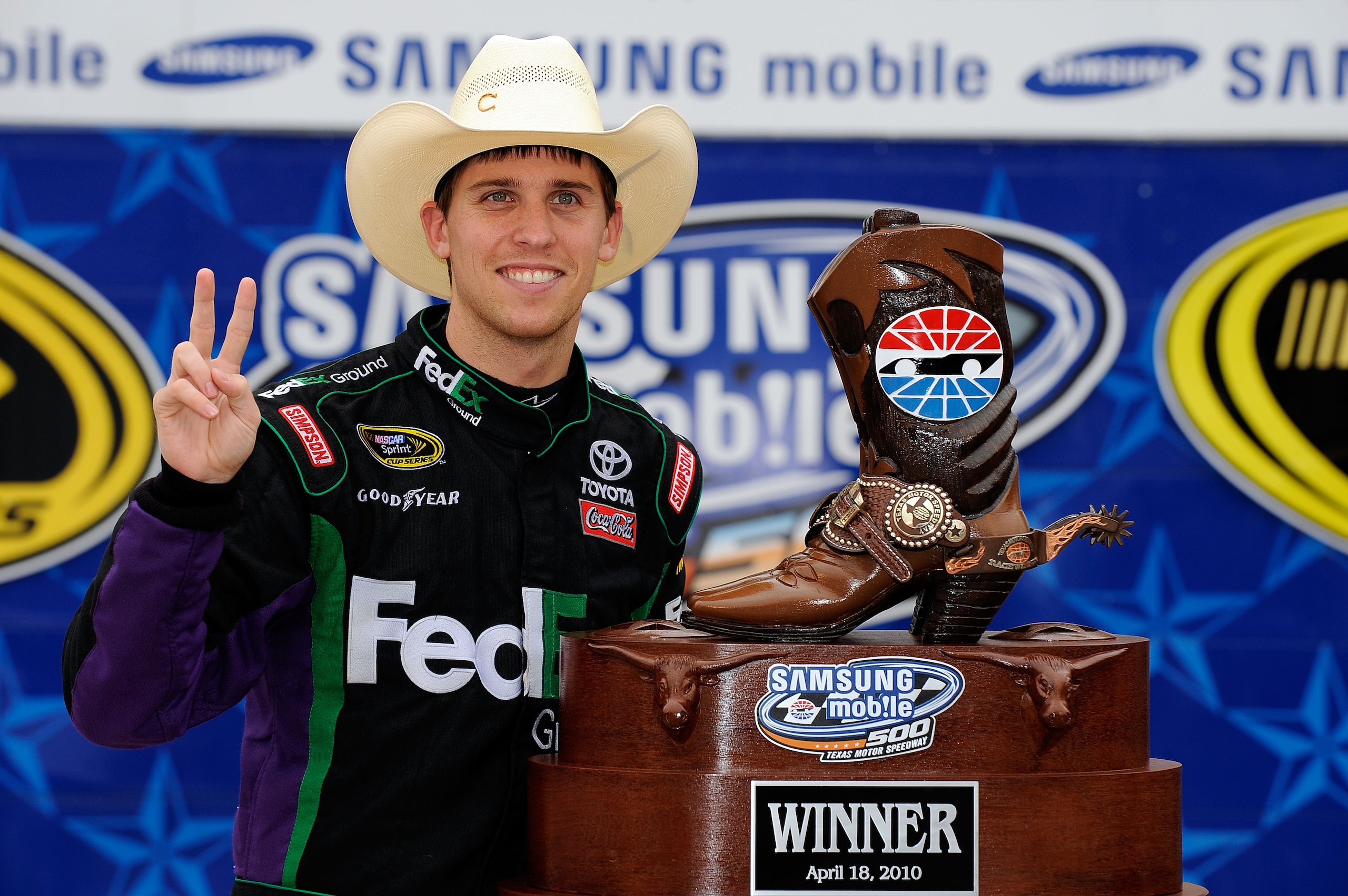 FORT WORTH, TX - APRIL 19:  Denny Hamlin, driver of the #11 of the FedEx Ground Toyota, poses with the trophy in victory lane after he won the NASCAR Sprint Cup Series Samsung Mobile 500 at Texas Motor Speedway on April 19, 2010 in Fort Worth, Texas.  (Ph