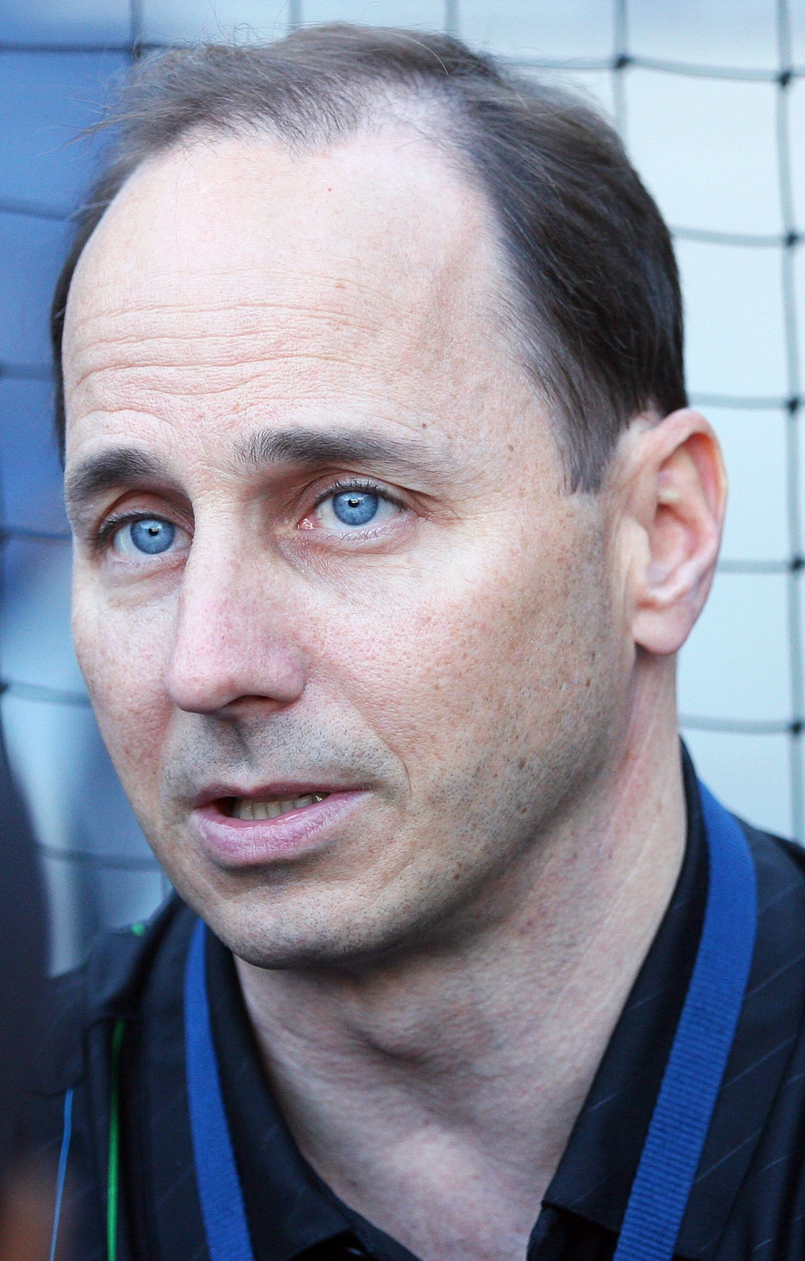 NEW YORK - OCTOBER 08:  Brian Cashman, general manager of the New York Yankees watches the team warm up prior to game three, to take place on October 9, of the America League Division Series against the Minnesota Twins at Yankee Stadium on October 8, 2010