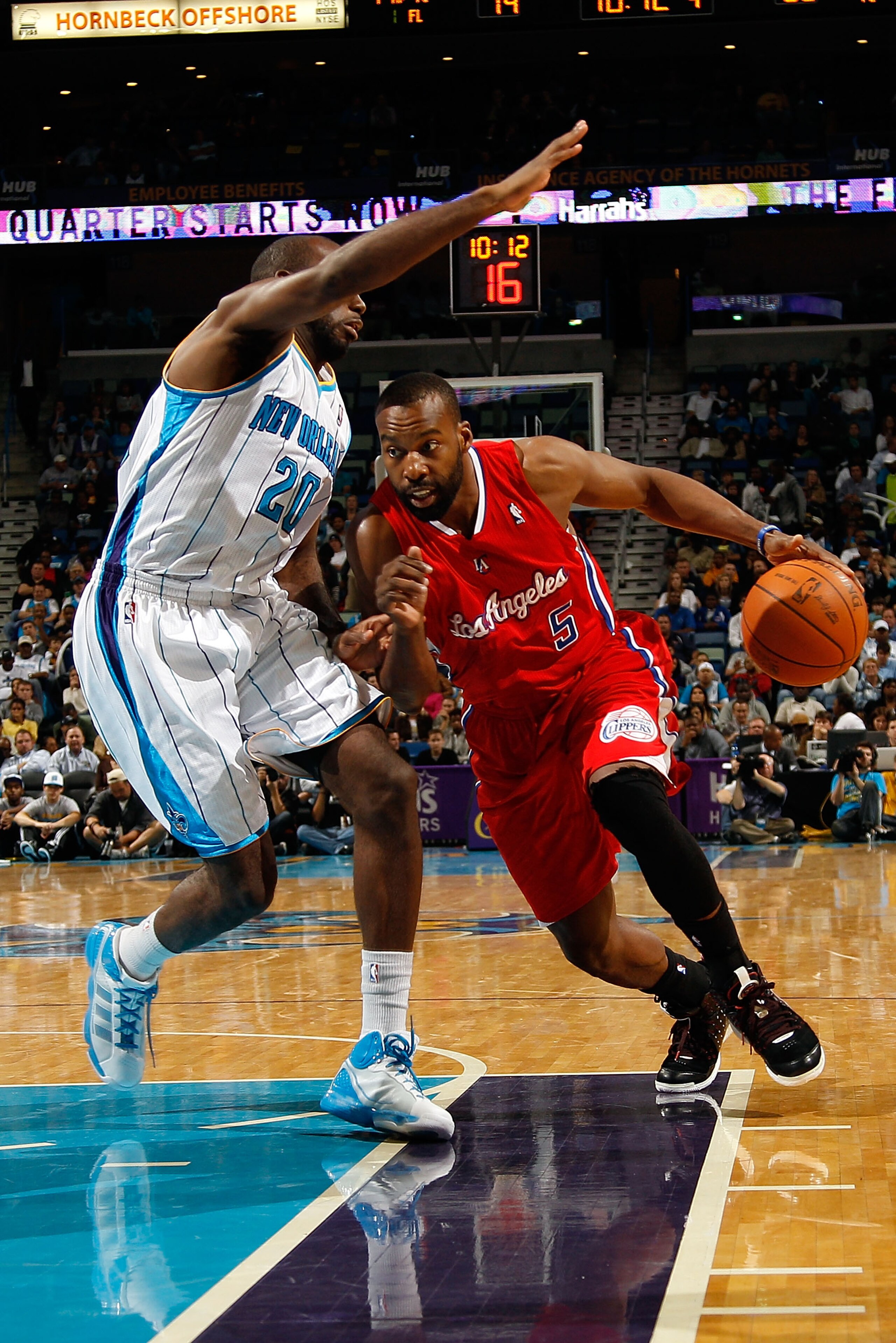 NEW ORLEANS - NOVEMBER 09:  Baron Davis #5 of the Los Angeles Clippers drives the ball around Quincy Pondexter #20 of the New Orleans Hornets at the New Orleans Arena on November 9, 2010 in New Orleans, Louisiana. The Hornets defeated the Clippers 101-82.
