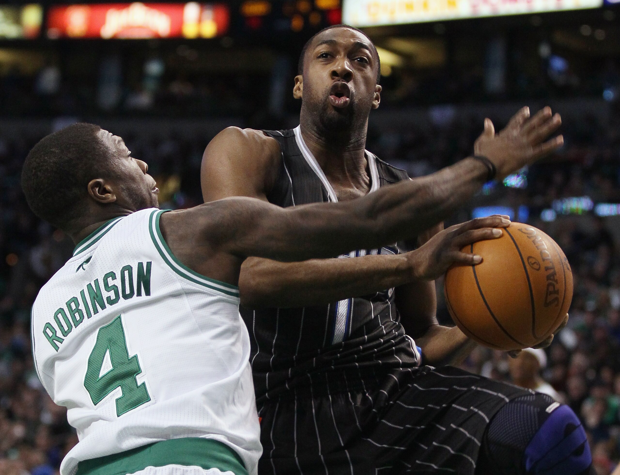 BOSTON, MA - JANUARY 17:   Gilbert Arenas #1 of the Orlando Magic heads for the basket as Nate Robinson #4 of the Boston Celtics defends on January 17, 2011 at the TD Garden in Boston, Massachusetts. The Celtics defeated the Magic 109-106.  NOTE TO USER: