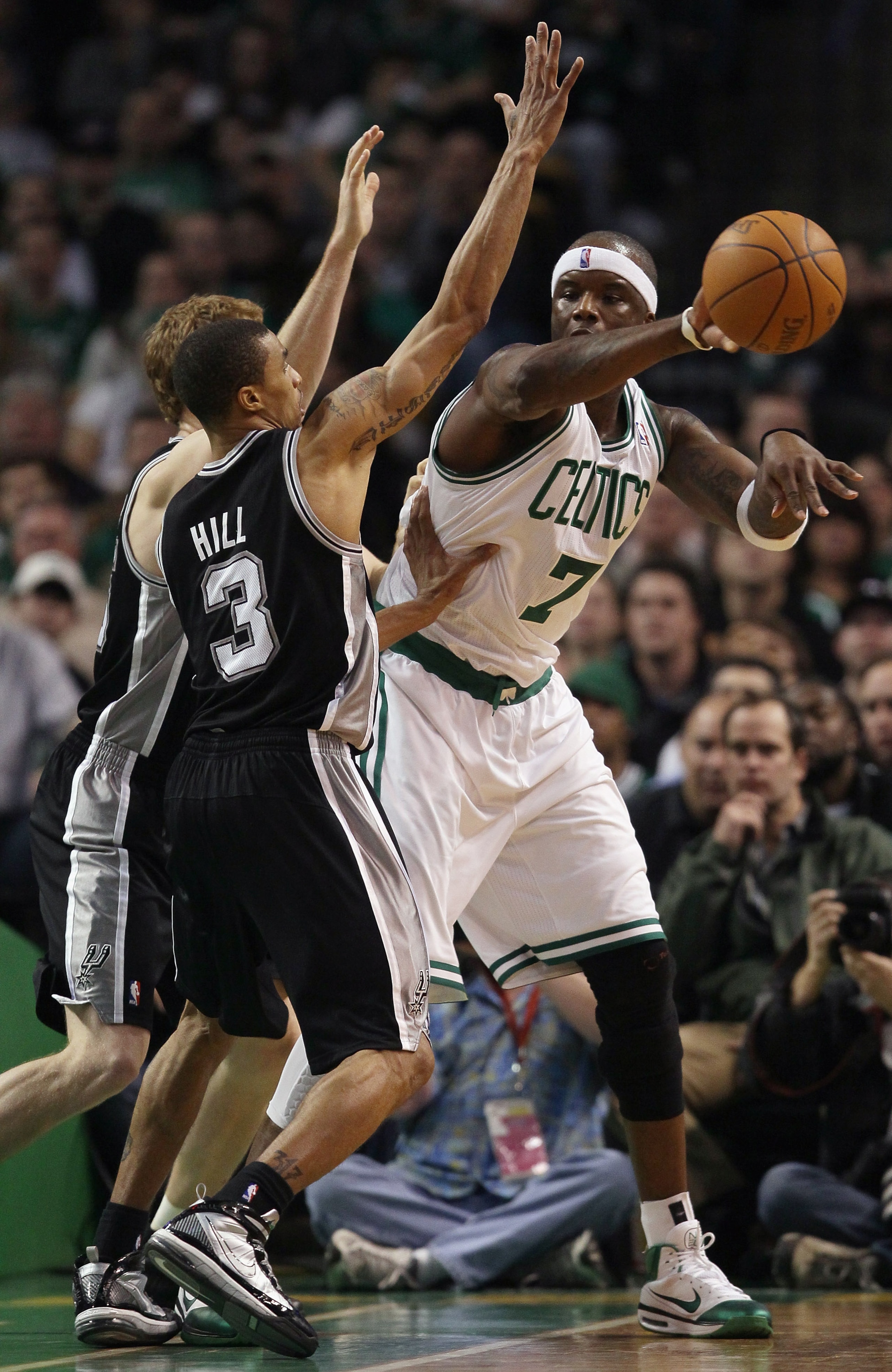 BOSTON, MA - JANUARY 05:  Jermaine O'Neal #7 of the Boston Celtics passes the ball around George Hill #3 and Matt Bonner #15 of the San Antonio Spurs on January 5, 2011 at the TD Garden in Boston, Massachusetts. The Celtics defeated the Spurs 105-103. NOT