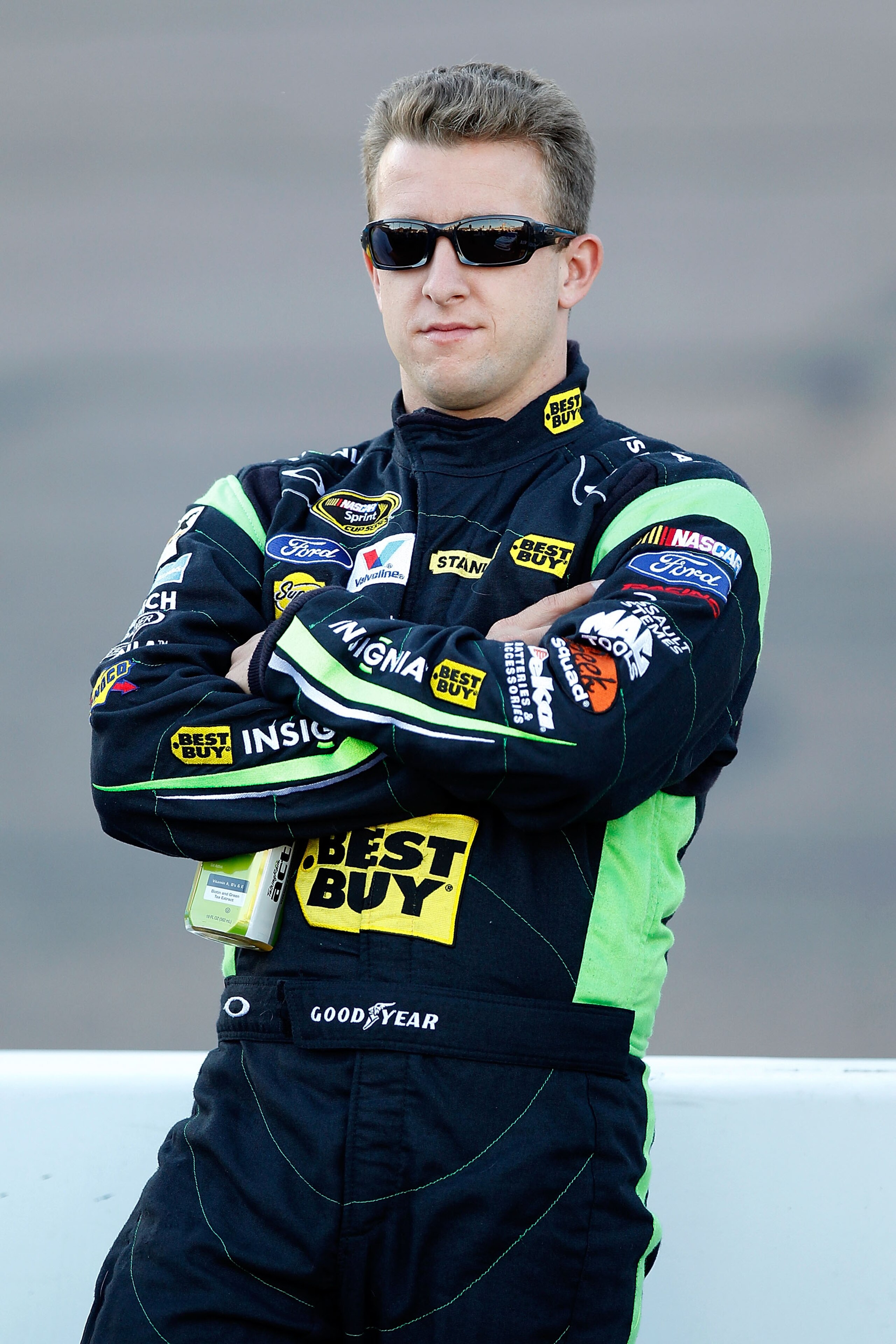 AVONDALE, AZ - NOVEMBER 12: A.J. Allmendinger, driver of the #43 Insignia HDTV Ford, stands on pit road during qualifying for the NASCAR Sprint Cup Series Kobalt Tools 500 at Phoenix International Raceway on November 12, 2010 in Avondale, Arizona.  (Photo