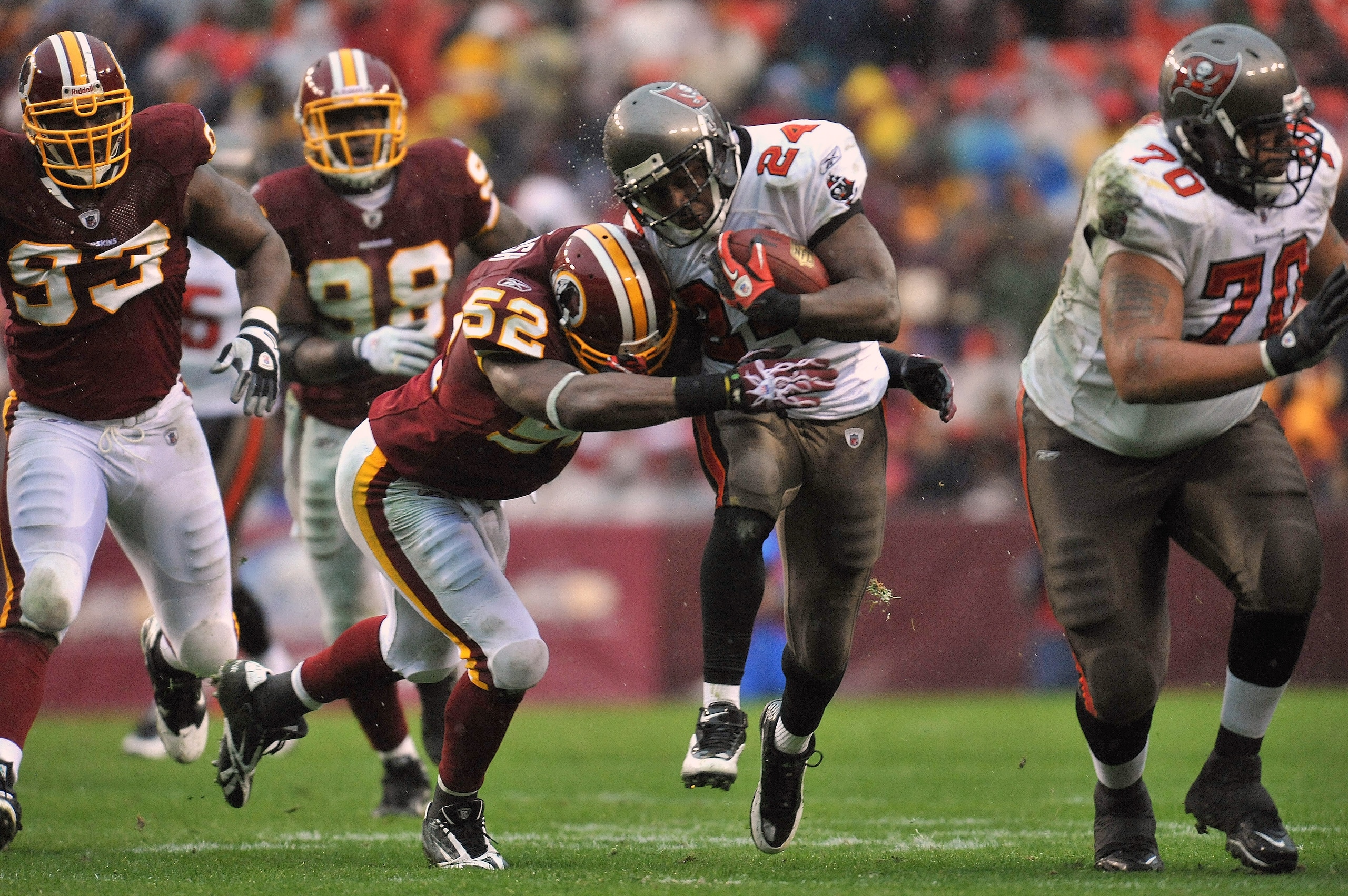 LANDOVER, MD - DECEMBER 12:  Carnell Williams #2 of the Tampa Bay Buccaneers runs the ball while Rocky Mcintosh #52 of the Washington Redskins defends at FedExField on December 12, 2010 in Landover, Maryland. The Buccaneers defeated the Redskins 17-16. (P