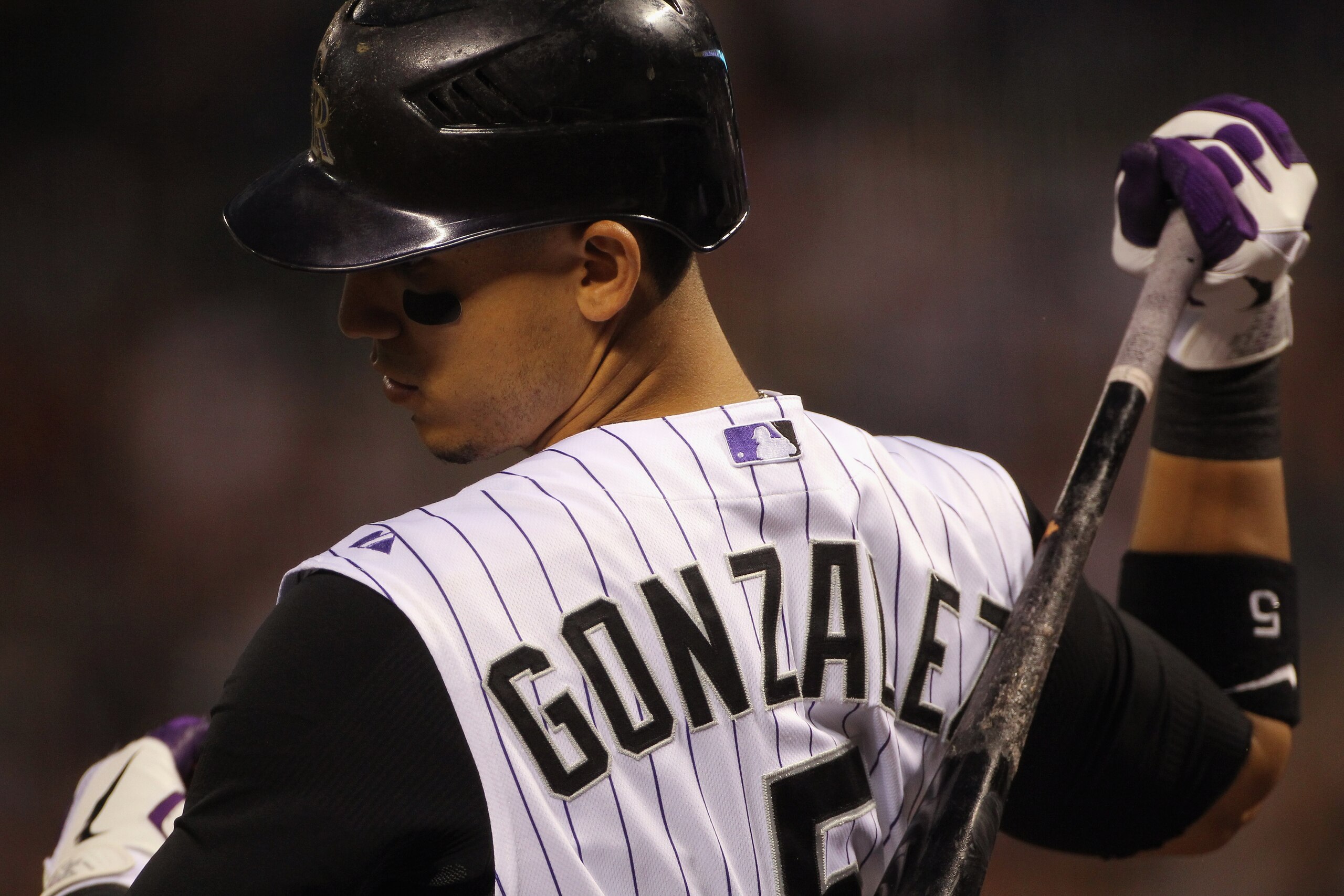 DENVER - SEPTEMBER 27:  Carlos Gonzalez #5 of the Colorado Rockies warms up on deck as he prepares to take an at bat against the Los Angeles Dodgers at Coors Field on September 25, 2010 in Denver, Colorado. The Dodgers defeated the Rockies 3-1.  (Photo by