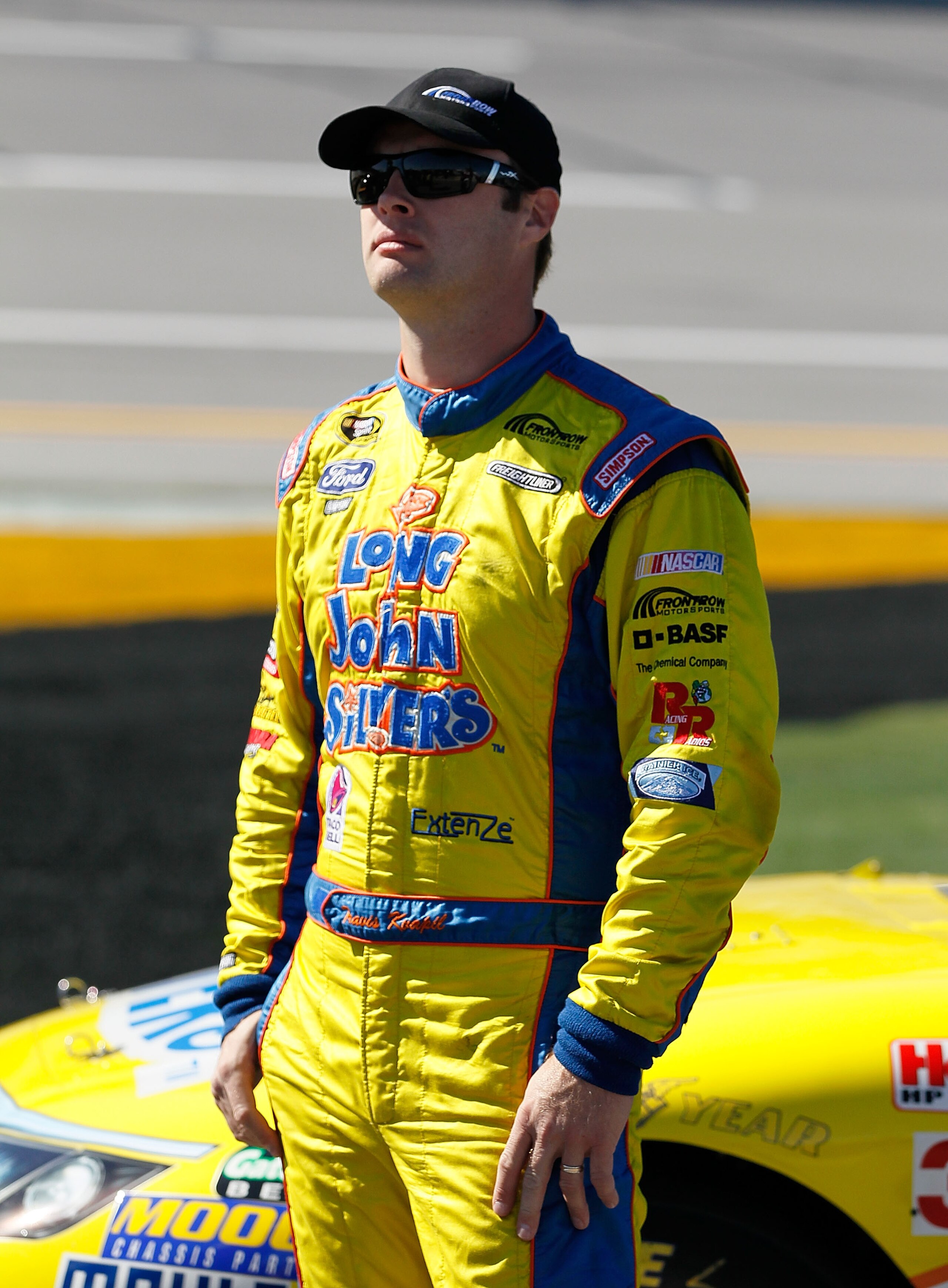 TALLADEGA, AL - OCTOBER 30:  Travis Kvapil, driver of the #38 Long John Silver's Ford, stands on pit road during qualifying for the NASCAR Sprint Cup Series AMP Energy Juice 500 at Talladega Superspeedway on October 30, 2010 in Talladega, Alabama.  (Photo