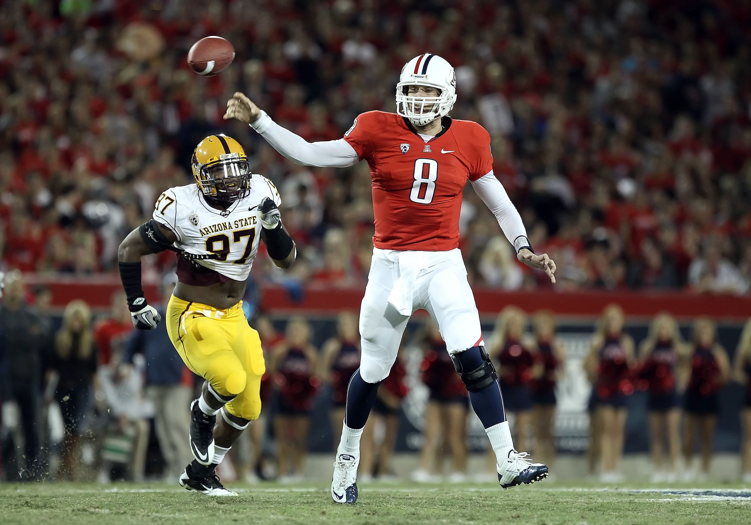 TUCSON, AZ - DECEMBER 02: Quarterback Nick Foles #8 of the Arizona Wildcats throws a pass under pressure from Junior Onyeali #97 of the Arizona State Sun Devils during the college football game at Arizona Stadium on December 2, 2010 in Tucson, Arizona. TUCSON, AZ - DECEMBER 02: Quarterback Nick Foles #8 of the Arizona Wildcats throws a pass under pressure from Junior Onyeali #97 of the Arizona State Sun Devils during the college football game at Arizona Stadium on December 2, 2010 in Tucson, Arizona.