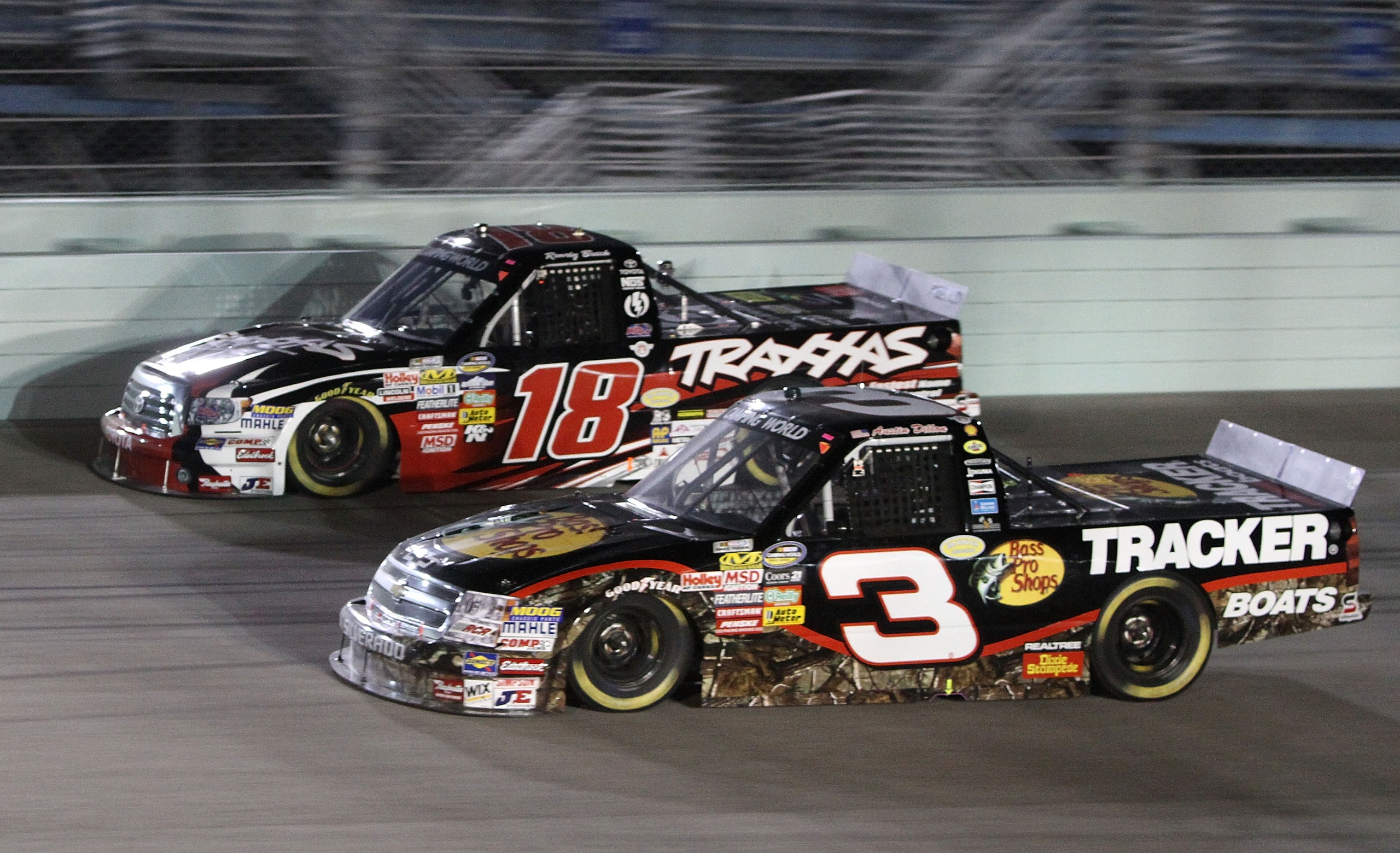 HOMESTEAD, FL - NOVEMBER 19:  Austin Dillon, driver of the 3# Bass Pro Shops/Tracker Boats Chevrolet, and Kyle Busch, driver of the #18 Toyota Tundra/TRAXXAS Toyota, race during the NASCAR Camping World Truck Series Ford 200 at Homestead-Miami Speedway on