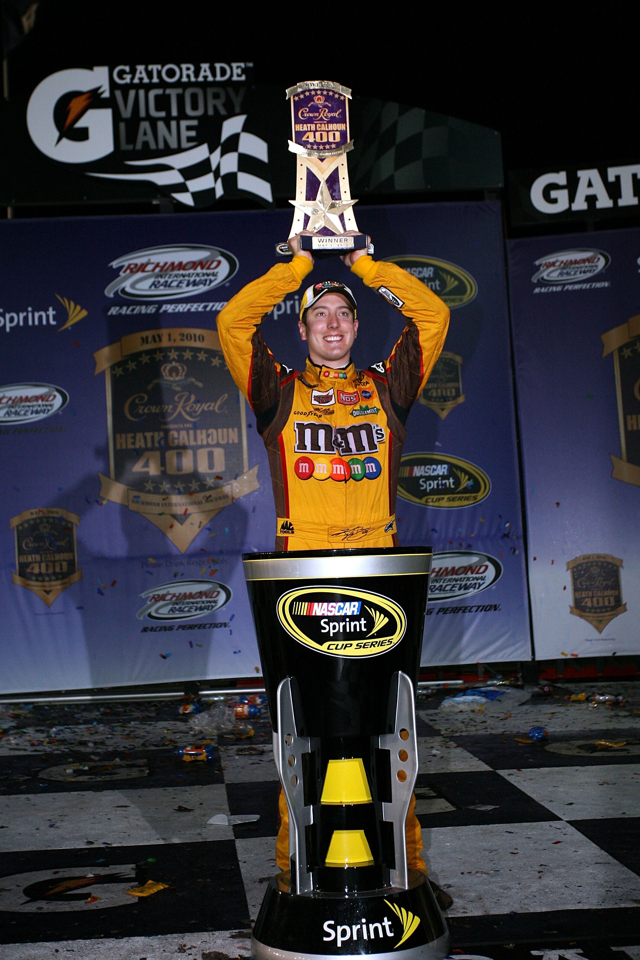 RICHMOND, VA - MAY 01:  Kyle Busch, driver of the #18 M&M's Toyota, celebrates with the trophy in victory lane after winning the NASCAR Sprint Cup Series Crown Royal Presents the Heath Calhoun 400 at Richmond International Raceway on May 1, 2010, 2010 in