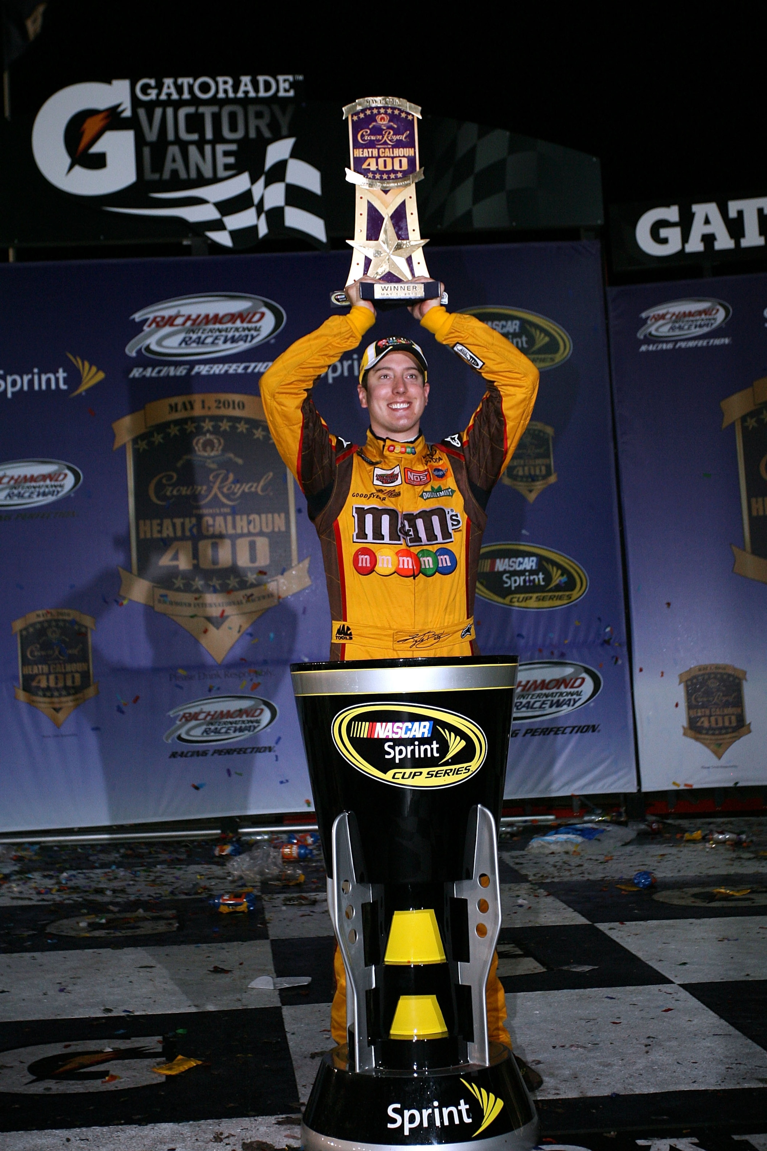 RICHMOND, VA - MAY 01:  Kyle Busch, driver of the #18 M&M's Toyota, celebrates with the trophy in victory lane after winning the NASCAR Sprint Cup Series Crown Royal Presents the Heath Calhoun 400 at Richmond International Raceway on May 1, 2010, 2010 in
