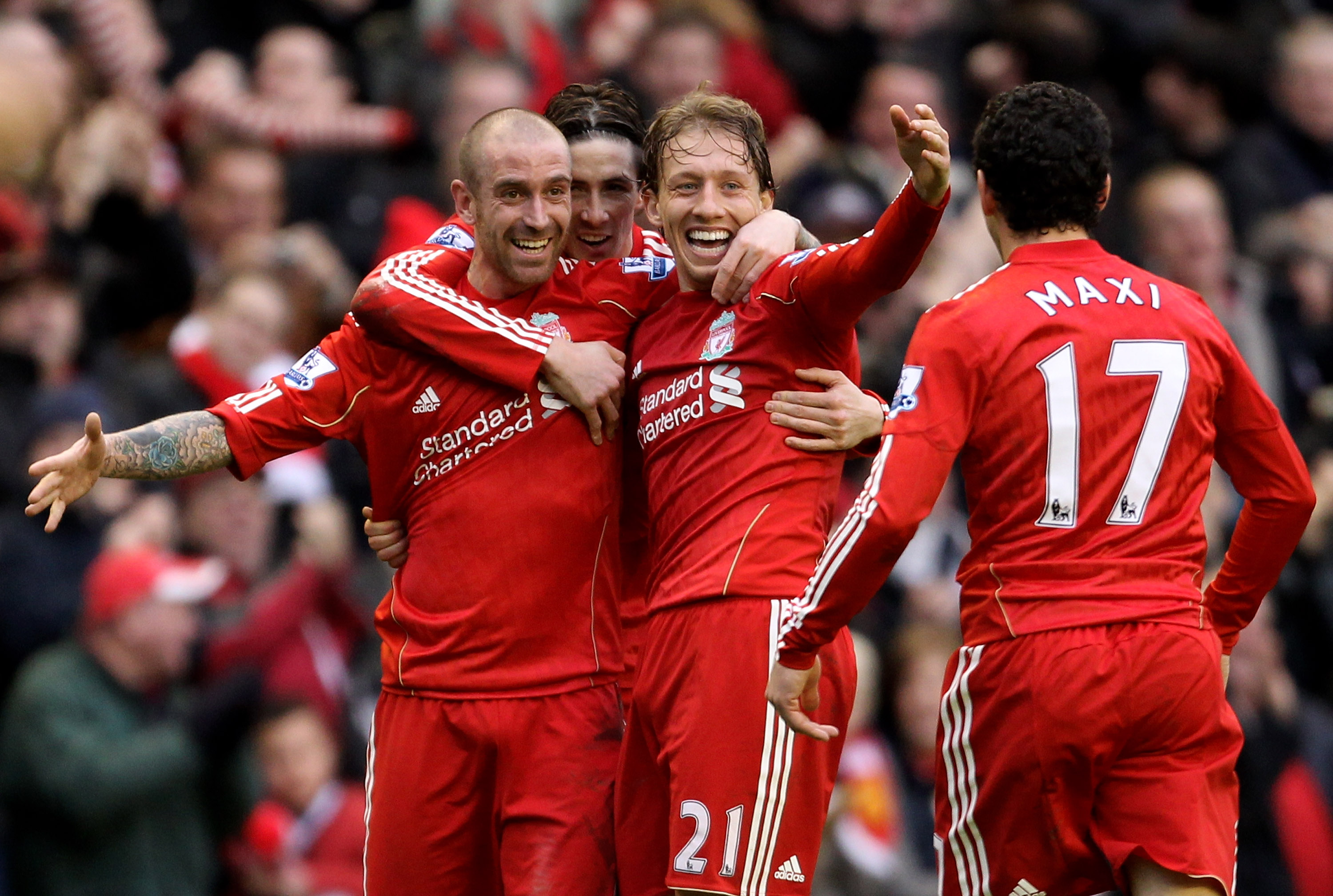 LIVERPOOL, ENGLAND - JANUARY 16:  Raul Meireles of Liverpool (L) celebrates scoring the opening goal with team mates Lucas, Maxi Rodriguez and Fernando Torres during the Barclays Premier League match between Liverpool and Everton at Anfield on January 16,