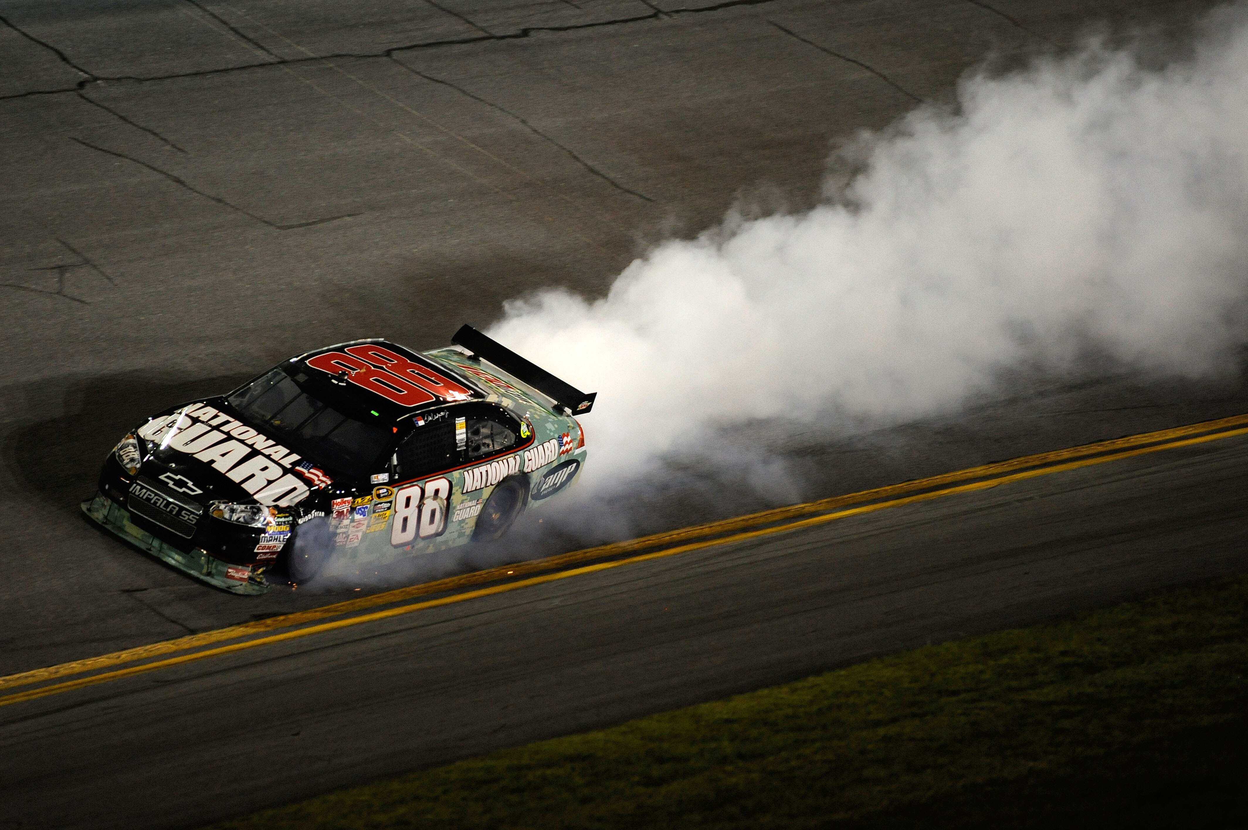 DAYTONA BEACH, FL - JULY 04: Dale Earnhardt Jr, driver of the #88 National Guard/AMP Energy Chevrolet, drives while smoke flows out of his car after  driving away from an on track collision during the NASCAR Sprint Cup Series 51st Annual Coke Zero 400 at