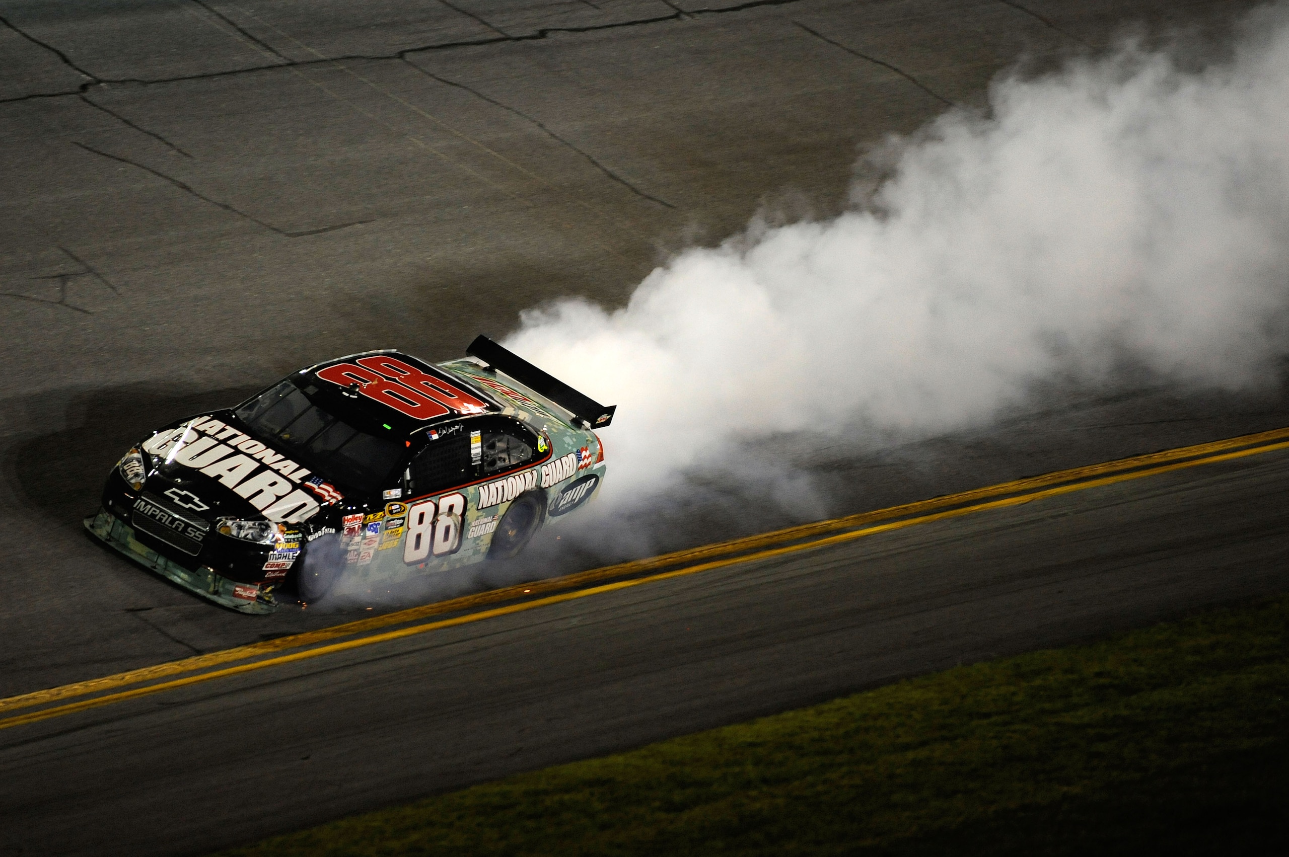 DAYTONA BEACH, FL - JULY 04: Dale Earnhardt Jr, driver of the #88 National Guard/AMP Energy Chevrolet, drives while smoke flows out of his car after  driving away from an on track collision during the NASCAR Sprint Cup Series 51st Annual Coke Zero 400 at