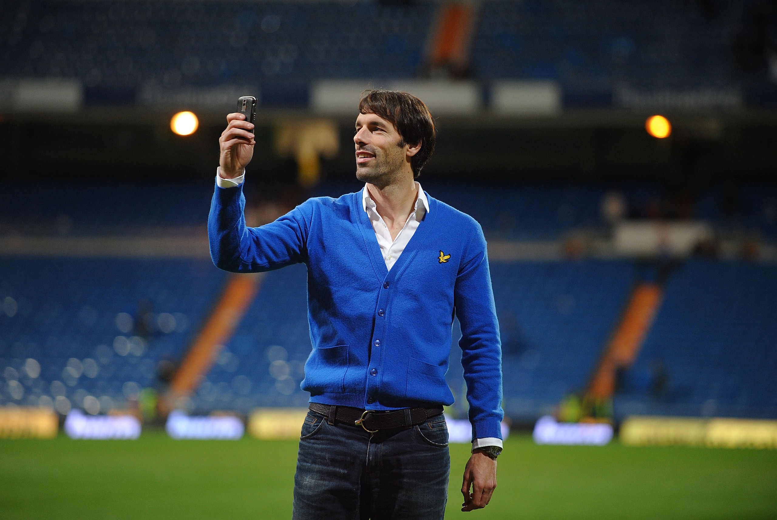 MADRID, SPAIN - JANUARY 24: Former Real Madrid striker Ruud Van Nistelrooy uses his phone to film fans applauding him at the Santiago Bernabeu stadium after the La Liga match between Real Madrid and Malaga on Sunday January 24, 2010 in Madrid Spain. Van MADRID, SPAIN - JANUARY 24: Former Real Madrid striker Ruud Van Nistelrooy uses his phone to film fans applauding him at the Santiago Bernabeu stadium after the La Liga match between Real Madrid and Malaga on Sunday January 24, 2010 in Madrid Spain. Van