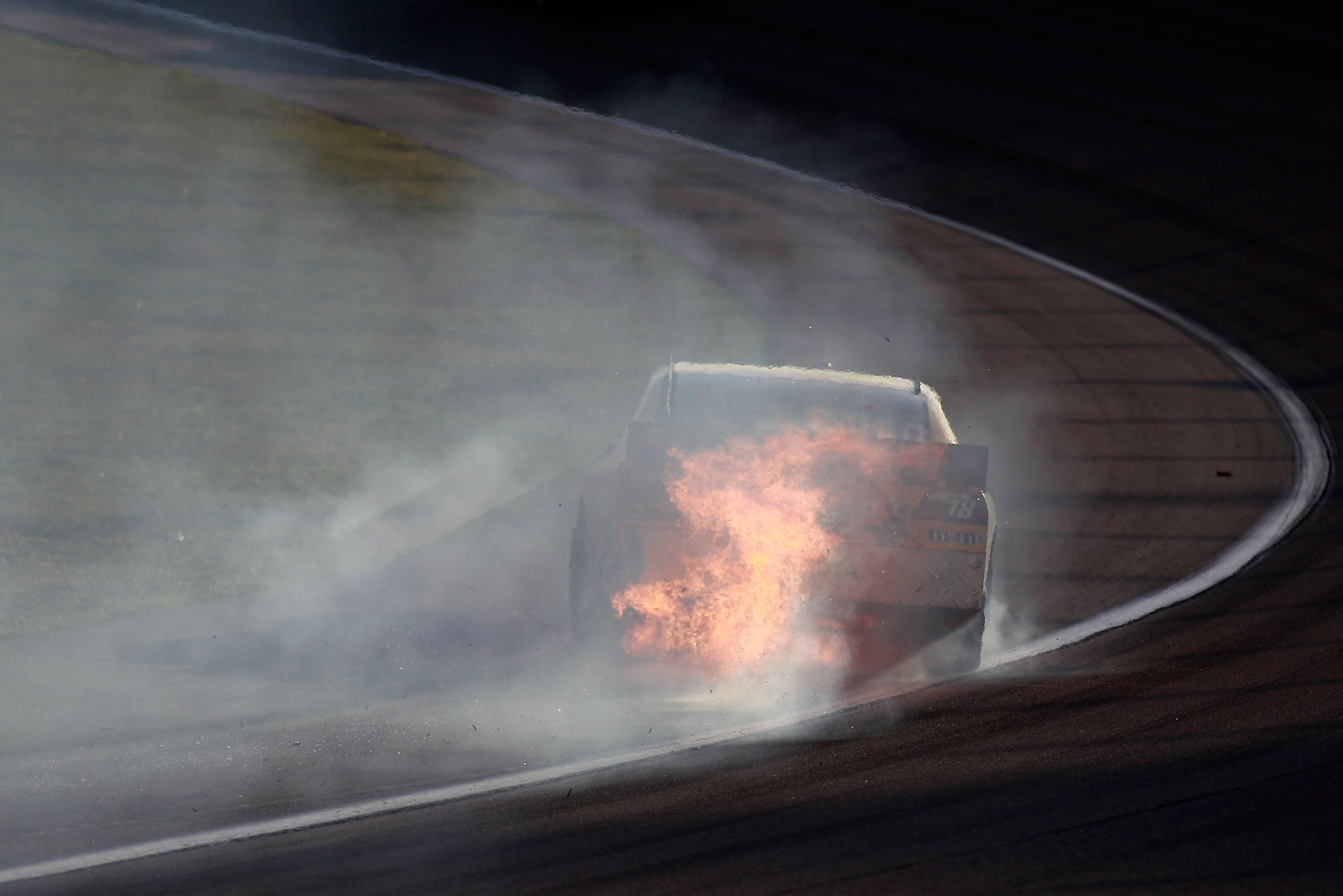 HOMESTEAD, FL - NOVEMBER 21:  Kyle Busch, driver of the #18 M&M'sToyota, drives with his car on fire after crashing during the NASCAR Sprint Cup Series Ford 400 at Homestead-Miami Speedway on November 21, 2010 in Homestead, Florida.  (Photo by Chris Grayt