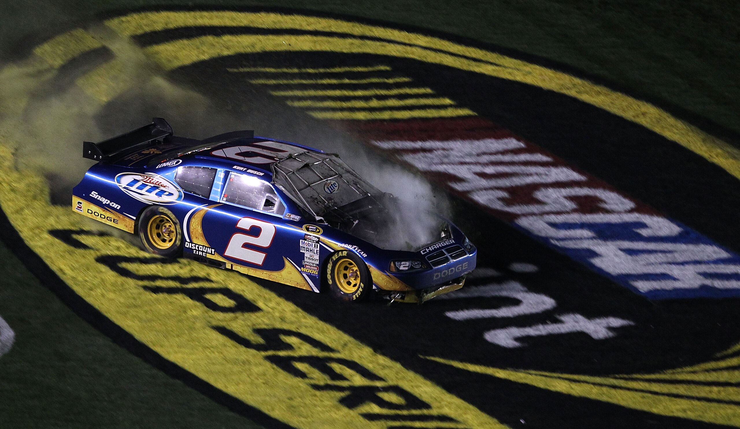 DAYTONA BEACH, FL - FEBRUARY 06:  Kurt Busch, driver of the #2 Miller Lite Dodge drives over grass after losing control on the front straight during the Budweiser Shootout at Daytona International Speedway on February 6, 2010 in Daytona Beach, Florida.  (