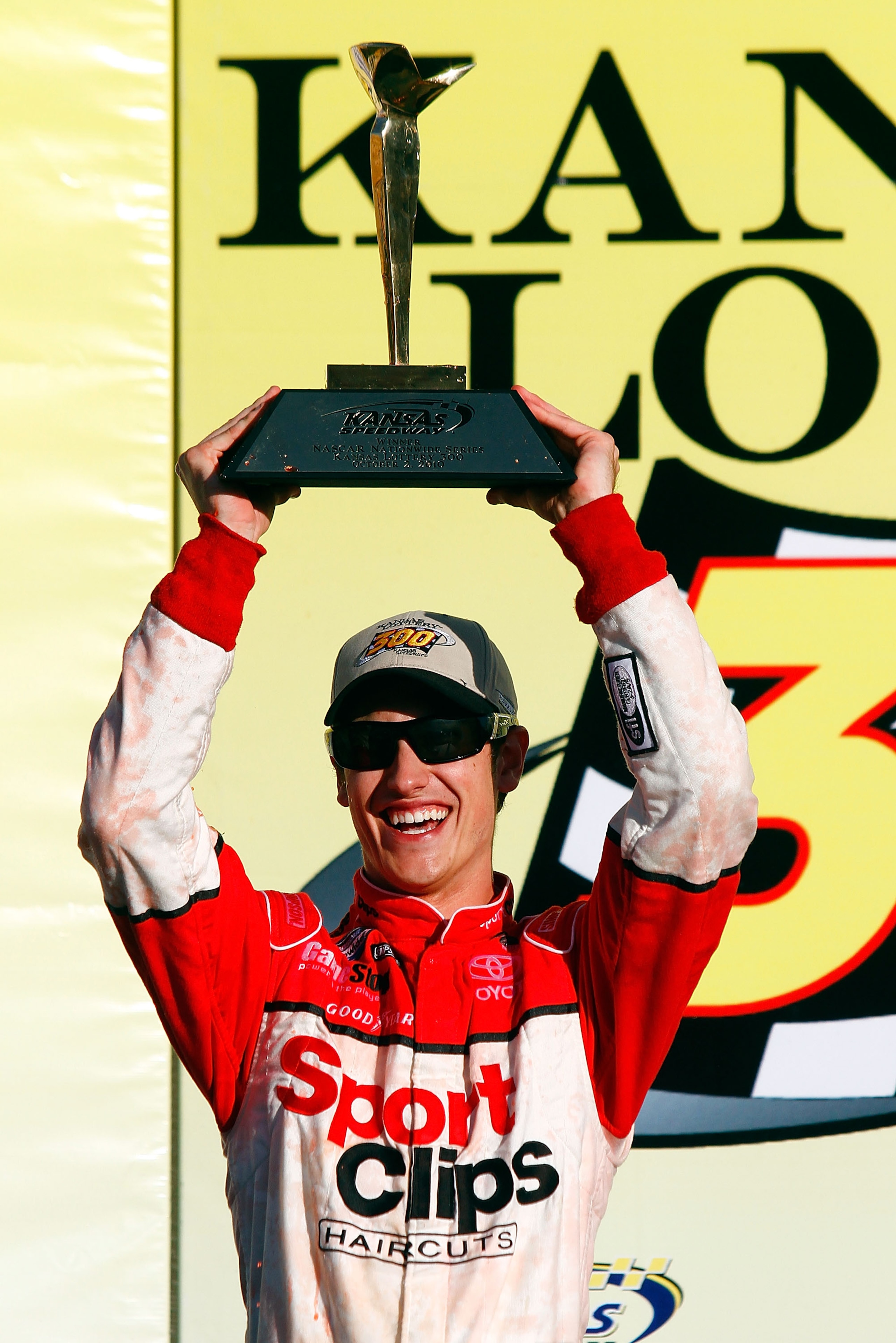 KANSAS CITY, KS - OCTOBER 02:  Joey Logano, driver of the #20 Sport Clips Toyota, celebrates in victory lane after winning the NASCAR Nationwide Series Kansas Lottery 300 on October 2, 2010 in Kansas City, Kansas.  (Photo by Jason Smith/Getty Images for N