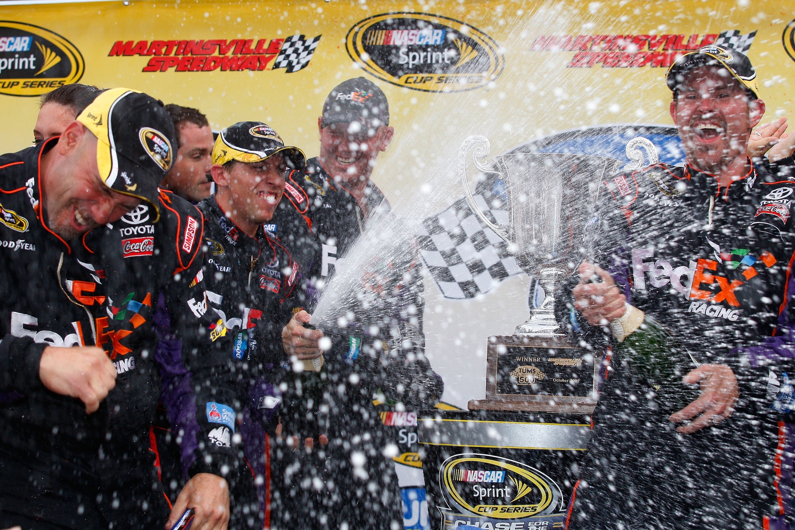 MARTINSVILLE, VA - OCTOBER 25:  Denny Hamlin, driver of the #11 FedEx Freight Toyota, celebrates in victory lane after winning the NASCAR Sprint Cup Series TUMS Fast Relief 500 at Martinsville Speedway on October 25, 2009 in Martinsville, Virginia.  (Phot