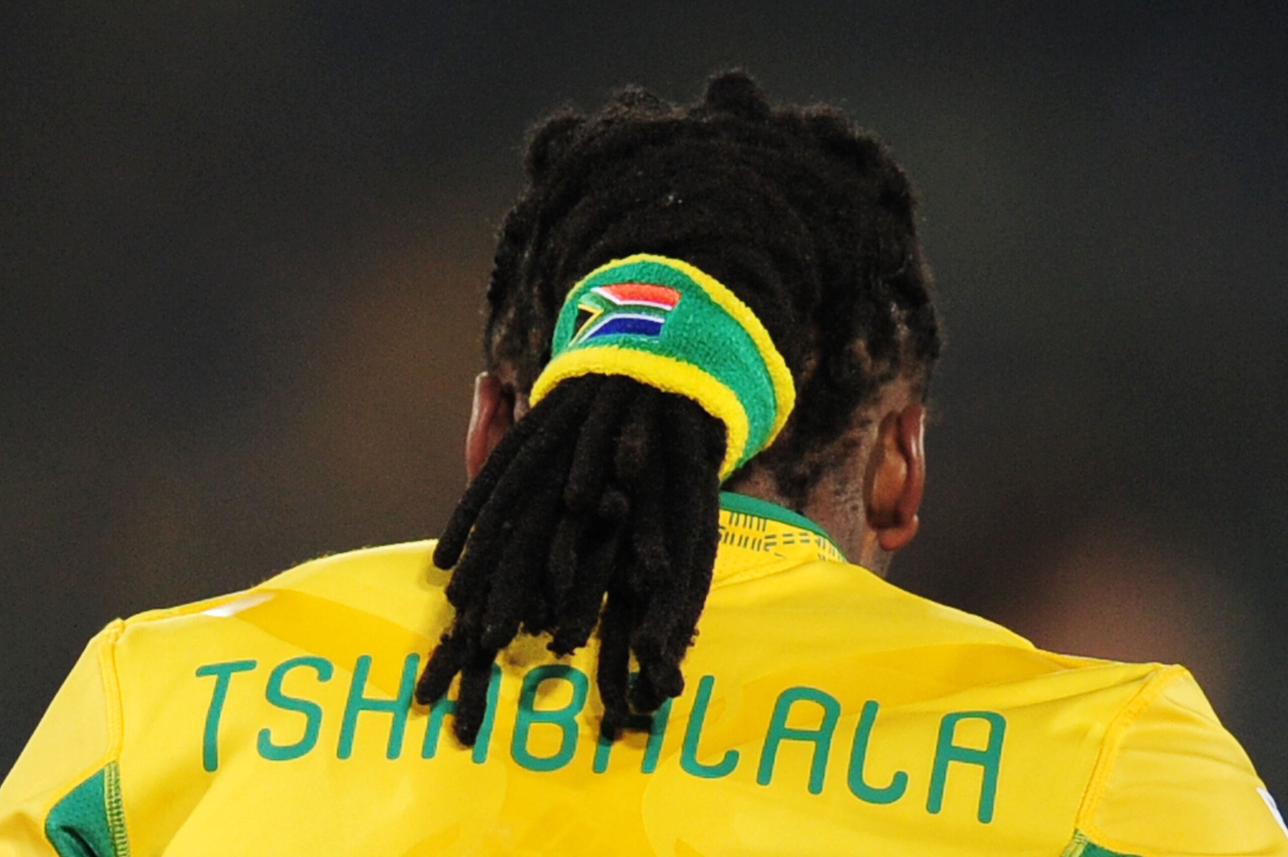 PRETORIA, SOUTH AFRICA - JUNE 16:  Siphiwe Tshabalala of South Africa holds his dreadlocks together in a hairband during the 2010 FIFA World Cup South Africa Group A match between South Africa and Uruguay at Loftus Versfeld Stadium on June 16, 2010 in Tsh