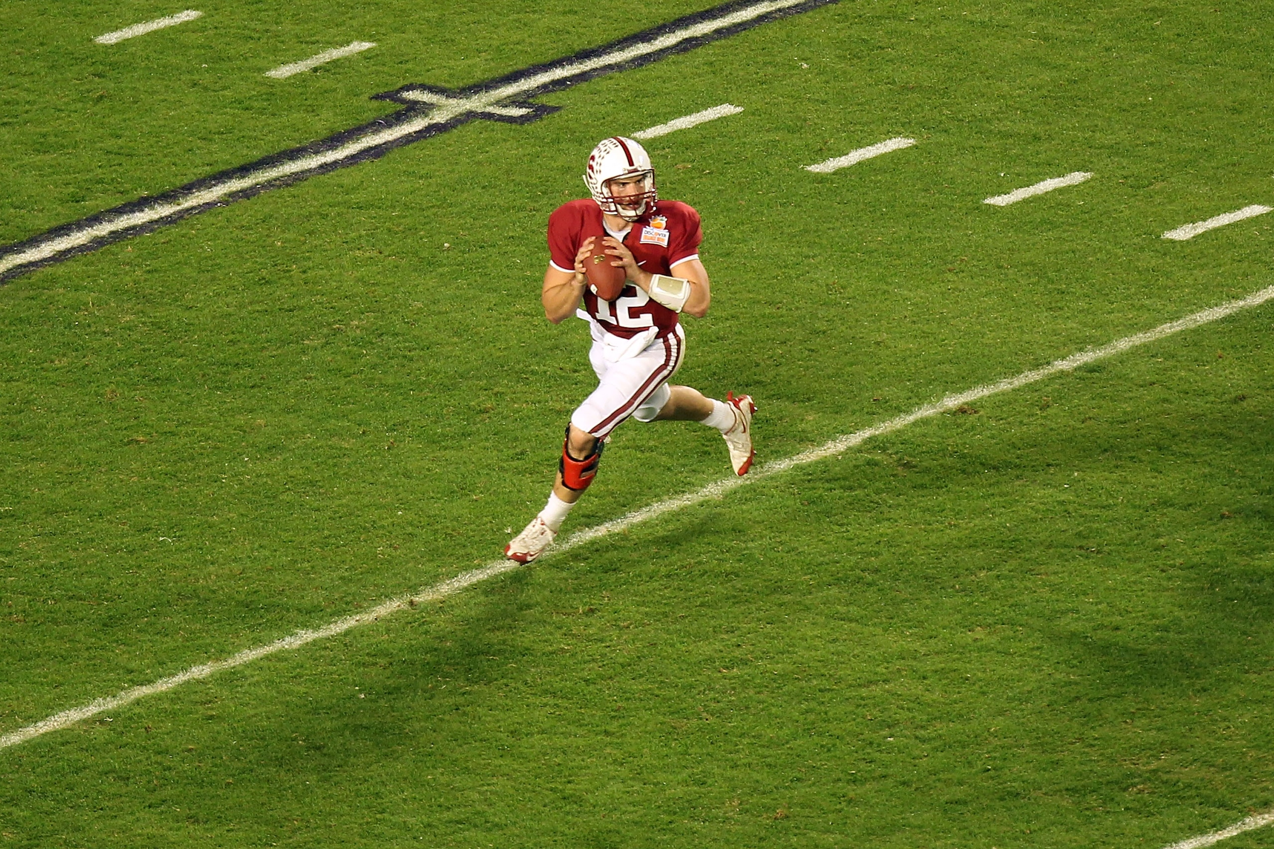 MIAMI, FL - JANUARY 03:  Quarterback Andrew Luck #12 of the Stanford Cardinal looks to pass as he rolls out of the pocket against the Virginia Tech Hokies during the 2011 Discover Orange Bowl at Sun Life Stadium on January 3, 2011 in Miami, Florida. Stanf