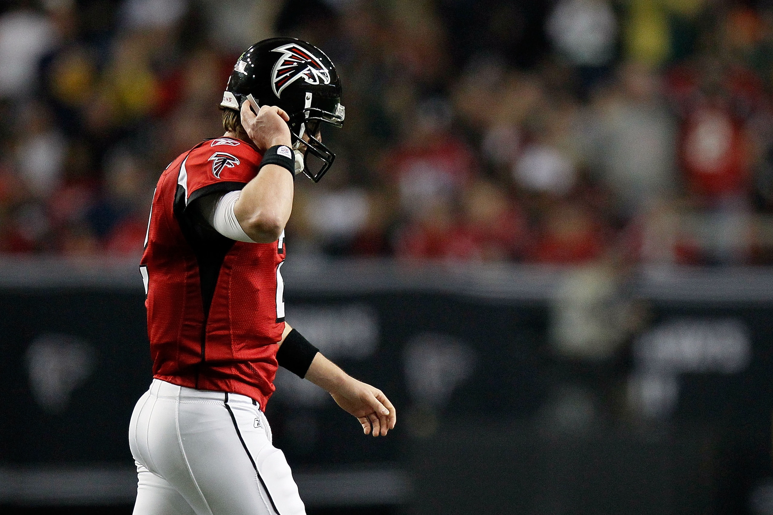 ATLANTA, GA - JANUARY 15:  Matt Ryan #2 of the Atlanta Falcons adjusts his helmet as he walks towards the sideline against the Green Bay Packers during their 2011 NFC divisional playoff game at Georgia Dome on January 15, 2011 in Atlanta, Georgia.  (Photo