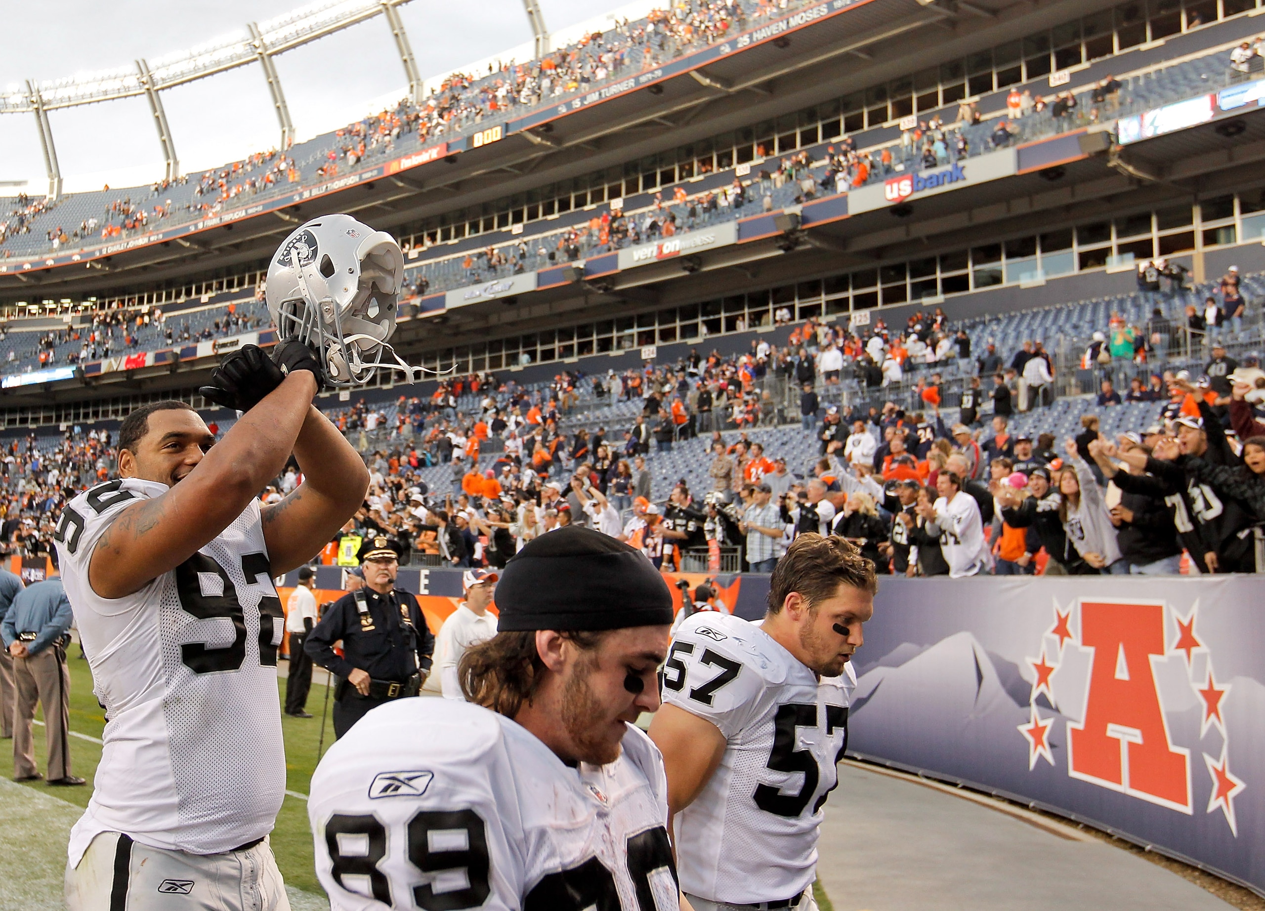 DENVER - OCTOBER 24:  Defensive end Richard Seymour #92 of the Oakland Raiders celebrates while the Raiders 59-14 over the Denver Broncos while walking off the field with teammates Nick Miller #89 and Ricky Brown #57 at INVESCO Field at Mile High on Octob