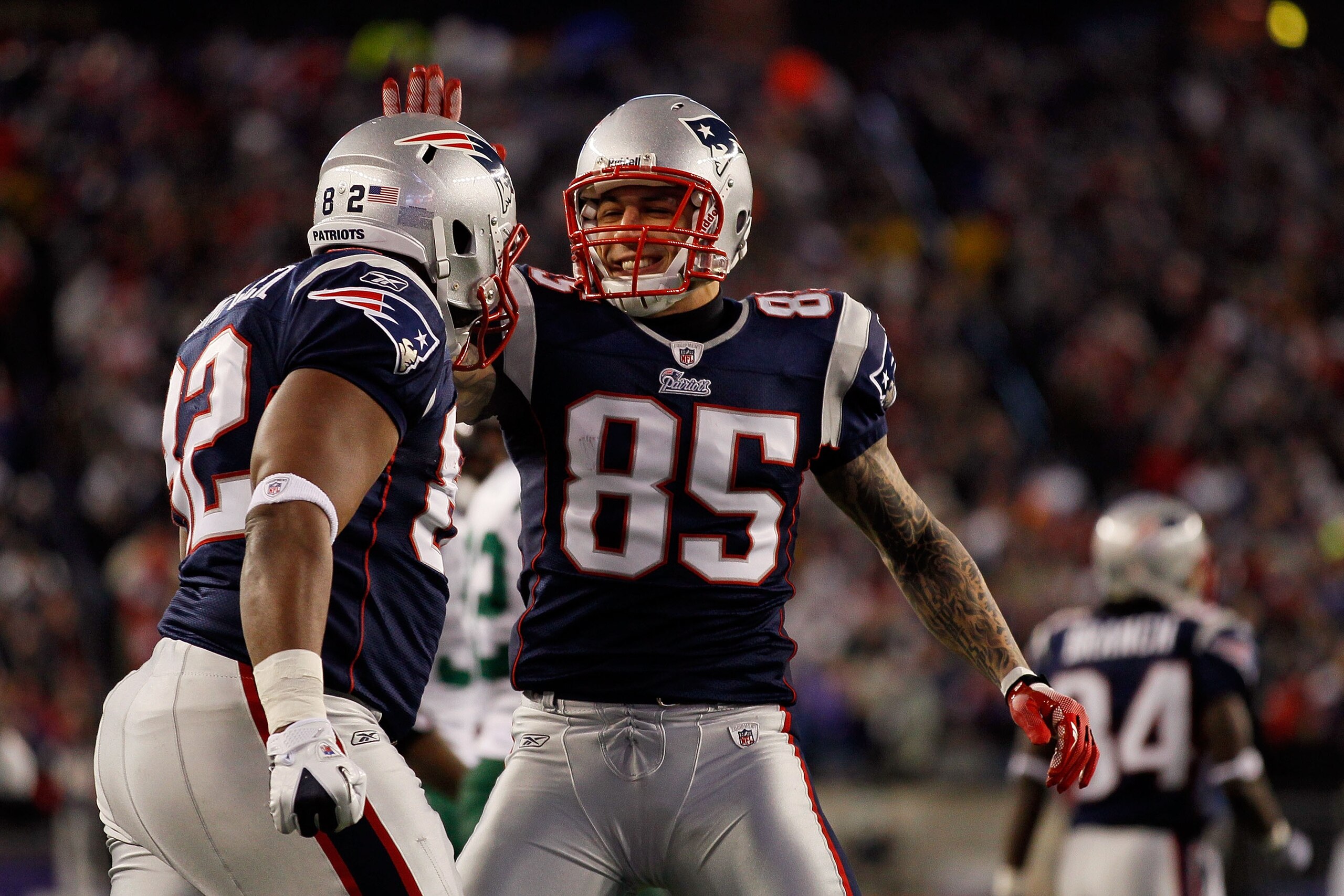 FOXBORO, MA - JANUARY 16:  Aaron Hernandez #85 and Alge Crumpler #82 of the New England Patriots celebrate Crumpler's catch during their 2011 AFC divisional playoff game at Gillette Stadium on January 16, 2011 in Foxboro, Massachusetts.  (Photo by Jim Rog