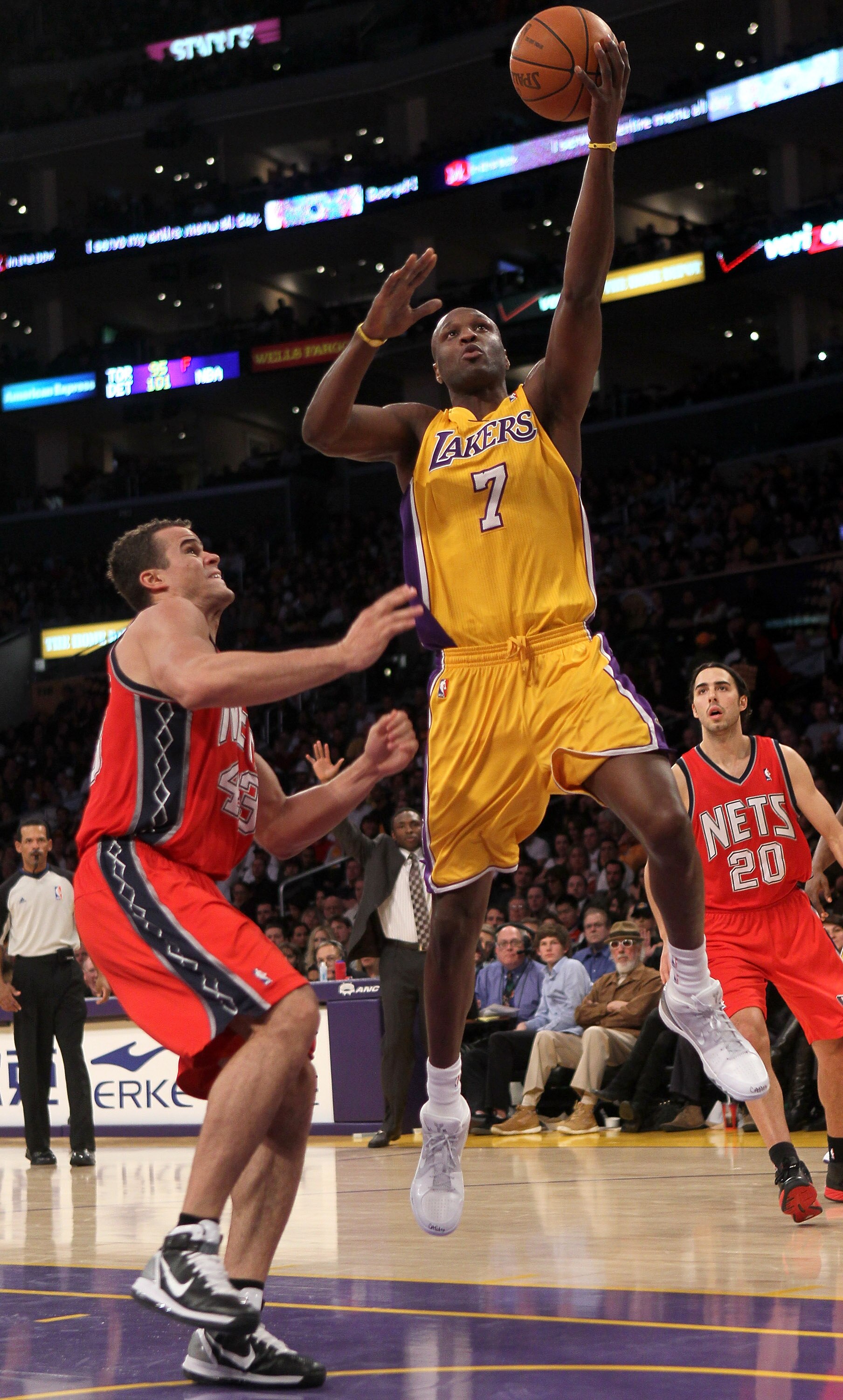 LOS ANGELES, CA - JANUARY 14: Lamar Odom #7 of the Los Angeles Lakers shoots over Kris Humphries #43 of the New Jersey Nets at Staples Center on January 14, 2011 in Los Angeles, California. The Lakers won 100-88.  NOTE TO USER: User expressly acknowledges