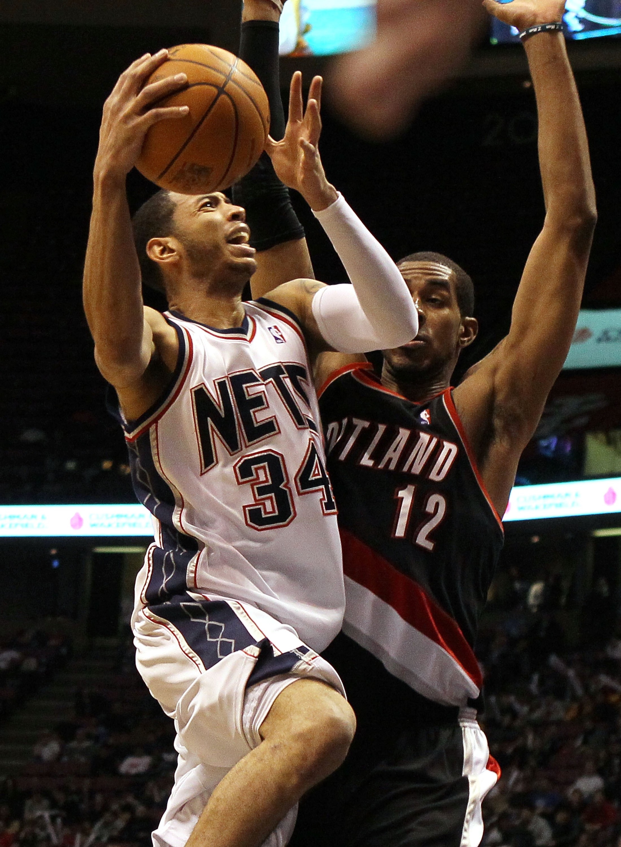 EAST RUTHERFORD, NJ - FEBRUARY 23:  Devin Harris #34 of the New Jersey Nets shoots against LaMarcus Aldridge #12 of the Portland Trail Blazers at the Izod Center on February 23, 2010 in East Rutherford, New Jersey.The Blazers defeated the Nets 102-93.NOTE
