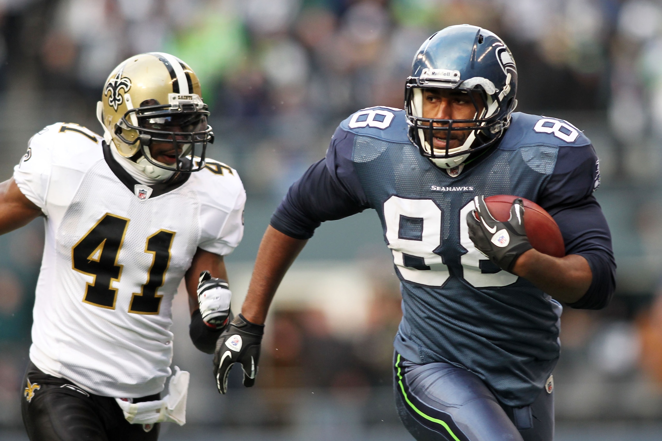 SEATTLE, WA - JANUARY 08:  Cameron Morrah #88 of the Seattle Seahawks runs down field against Roman Harper #41 of the New Orleans Saints during the 2011 NFC wild-card playoff game at Qwest Field on January 8, 2011 in Seattle, Washington.  (Photo by Jonath