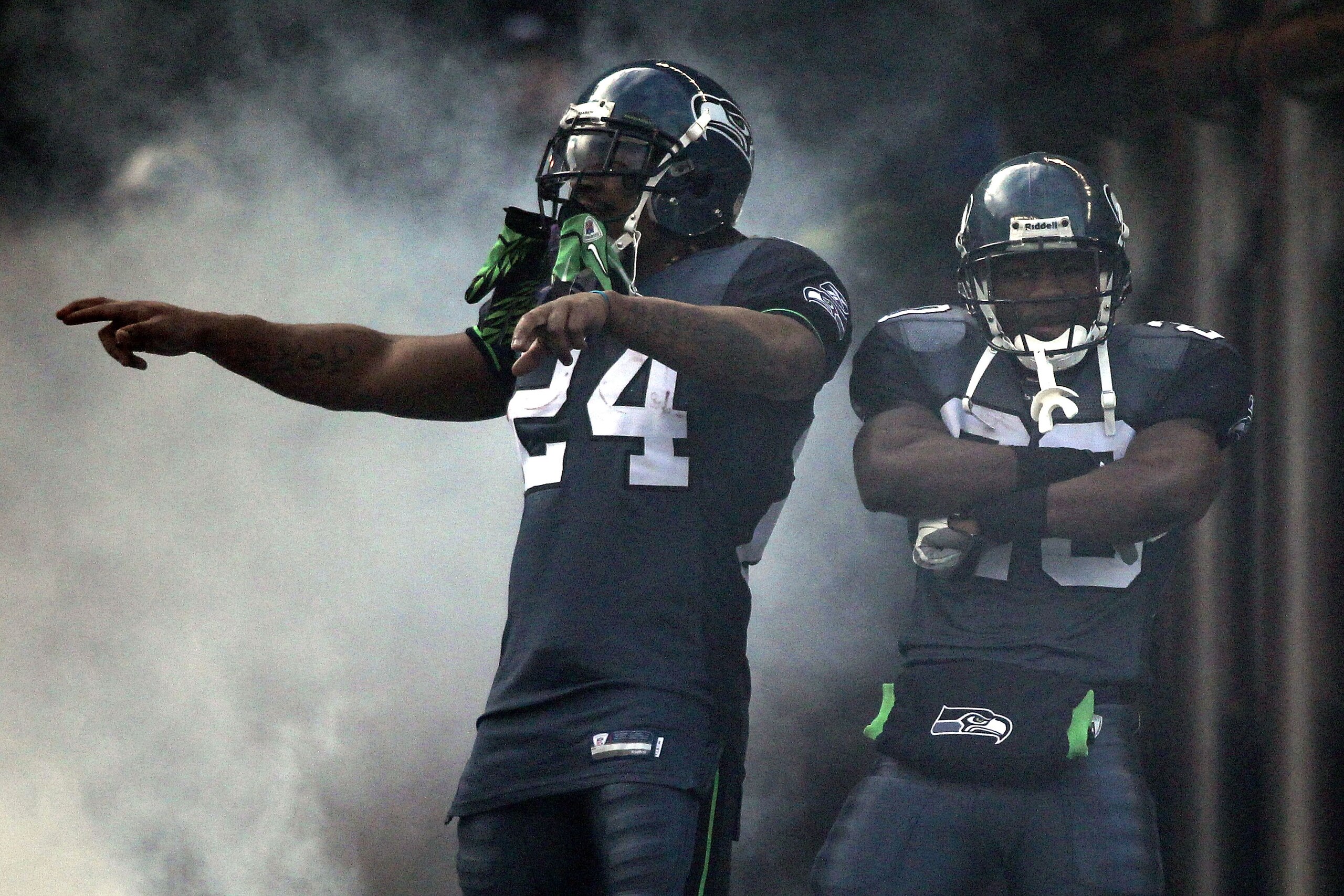 SEATTLE, WA - JANUARY 08:  Marshawn Lynch #24 of the Seattle Seahawks and Justin Forsett #20 pose during player introductions before taking on the New Orleans Saints during the 2011 NFC wild-card playoff game at Qwest Field on January 8, 2011 in Seattle,