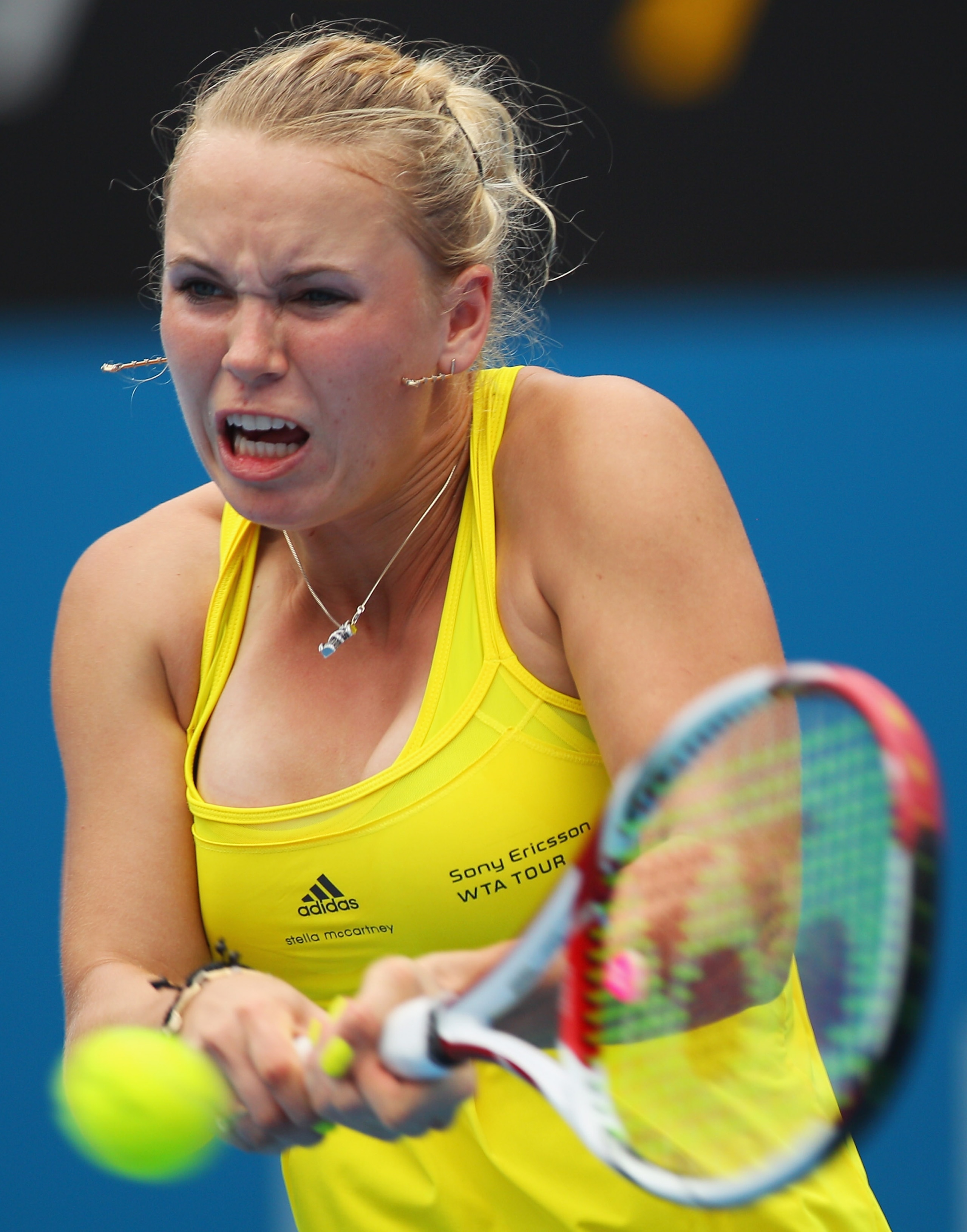 SYDNEY, AUSTRALIA - JANUARY 11:  Caroline Wozniacki of Denmark plays a backhand in her match against Dominika Cibulkova of Slovakia during day three of the 2011 Medibank International at Sydney Olympic Park Tennis Centre on January 11, 2011 in Sydney, Aus