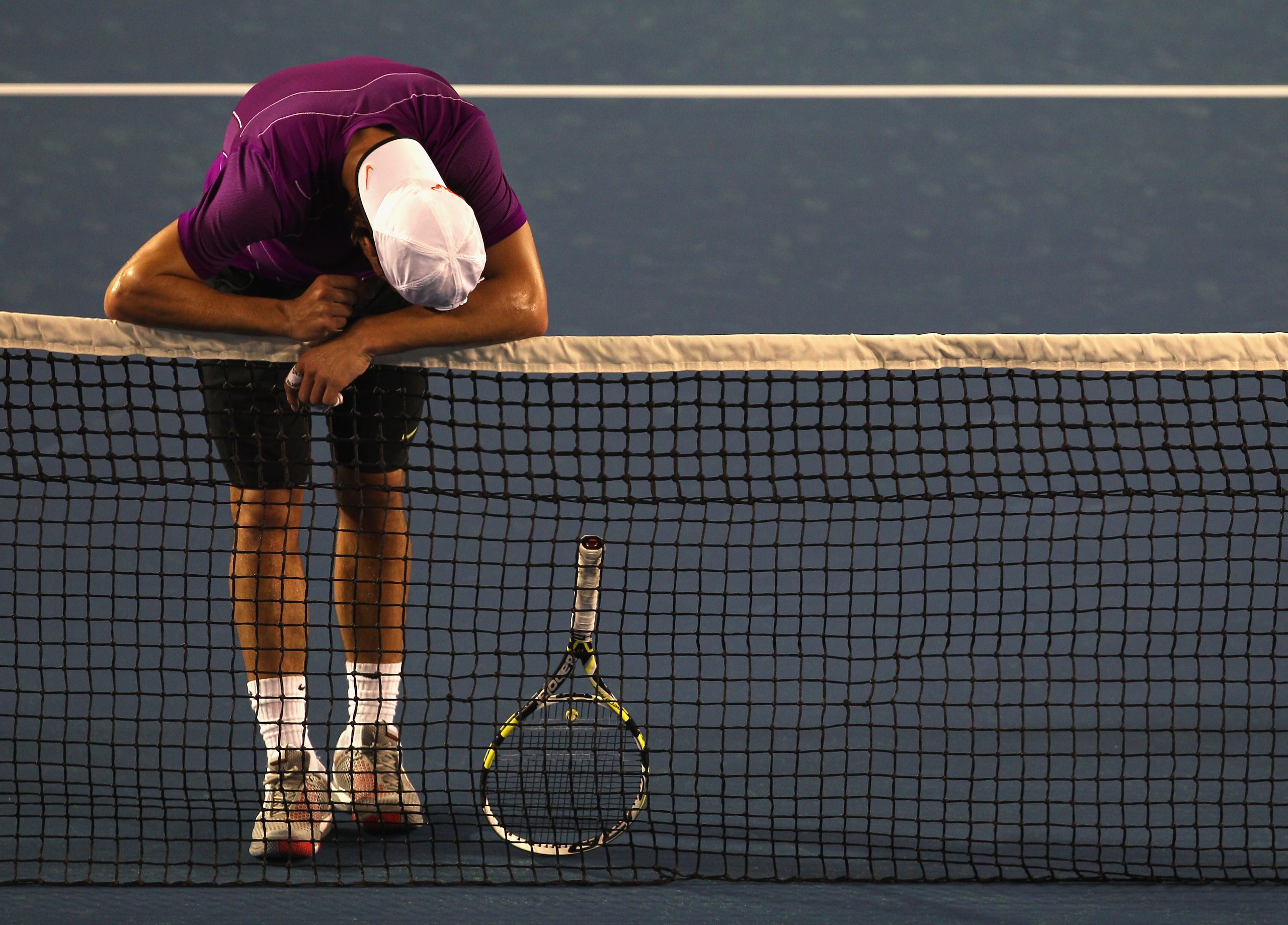 MELBOURNE, AUSTRALIA - JANUARY 12: Rafael Nadal of Spain rests on the net during a practice session ahead of the 2011 Australian Open at Melbourne Park on January 12, 2011 in Melbourne, Australia. (Photo by Mark Dadswell/Getty Images) MELBOURNE, AUSTRALIA - JANUARY 12: Rafael Nadal of Spain rests on the net during a practice session ahead of the 2011 Australian Open at Melbourne Park on January 12, 2011 in Melbourne, Australia. (Photo by Mark Dadswell/Getty Images)