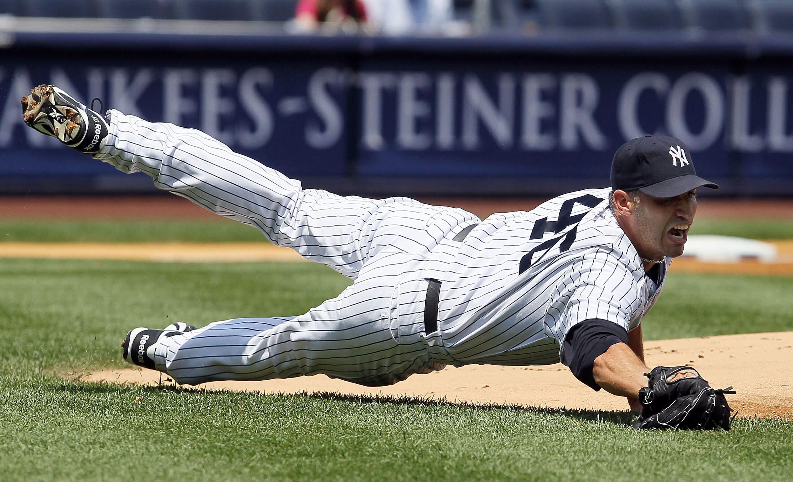 NEW YORK - JULY 18:  Andy Pettitte #46 of the New York Yankees fields a ball bunted by Carl Crawfor (not pictured) of the Tampa Bay Rays during the first inning on July 18, 2010 at Yankee Stadium in the Bronx borough of New York City.  (Photo by Jim McIsa
