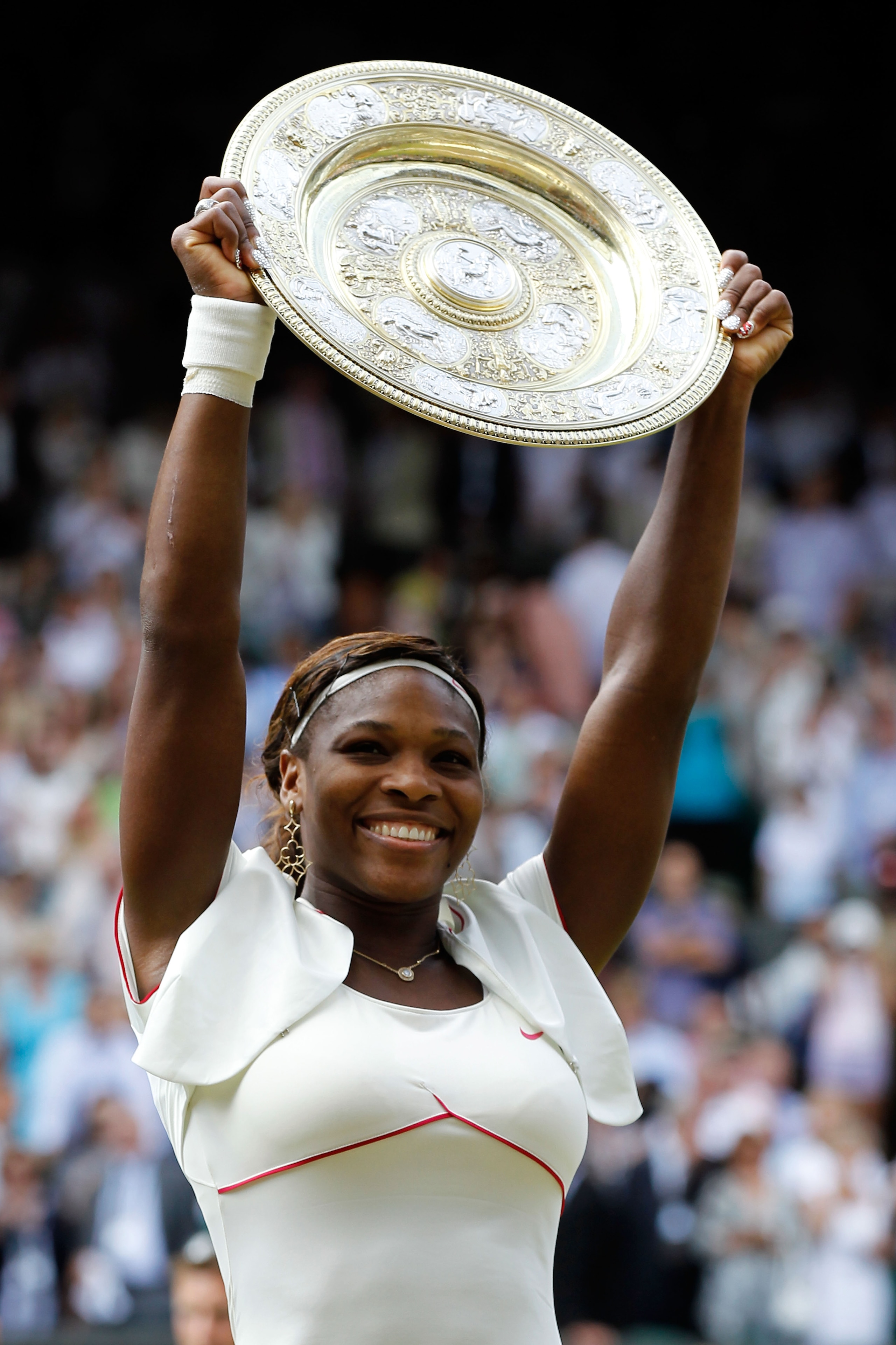 LONDON, ENGLAND - JULY 03:  Serena Williams of USA lifts the Championship trophy after winning her Ladies Singles Final Match against Vera Zvonareva of Russia on Day Twelve of the Wimbledon Lawn Tennis Championships at the All England Lawn Tennis and Croq