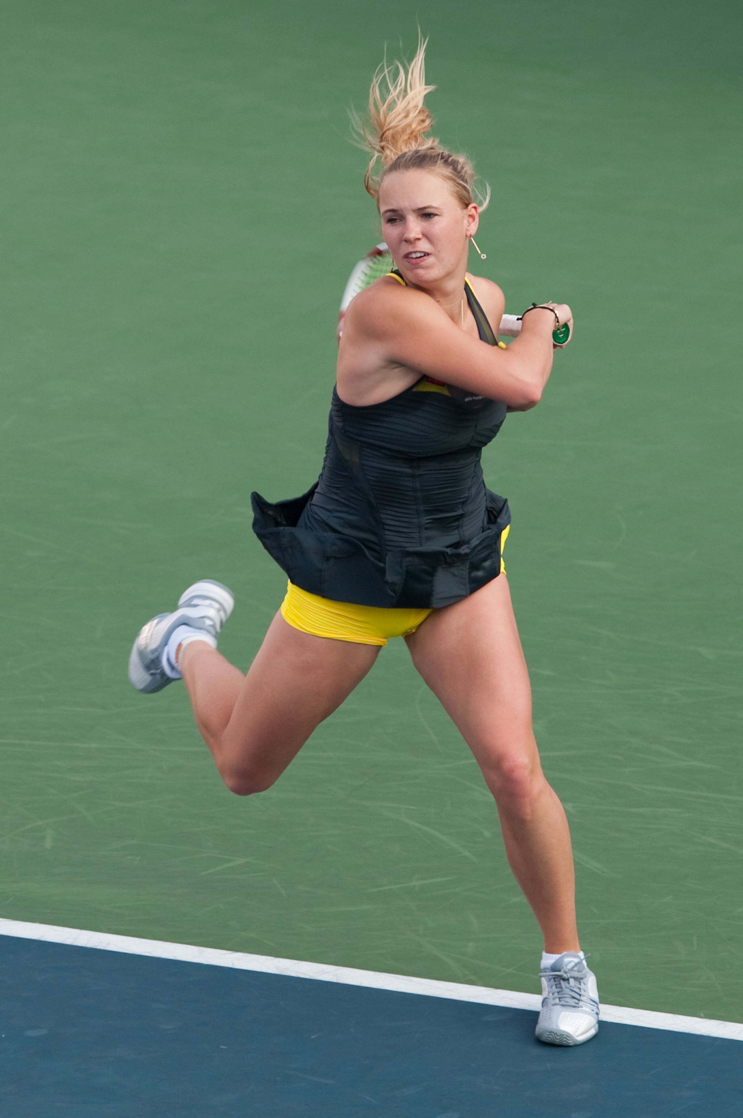 HONG KONG - JANUARY 08:  Caroline Wozniacki of Denmark plays a forehand during her match against Vera Zvonareva of Russia during day four of the Hong Kong Tennis Classic 2011 on January 8, 2011 in Hong Kong, China.  (Photo by Victor Fraile/Getty Images)