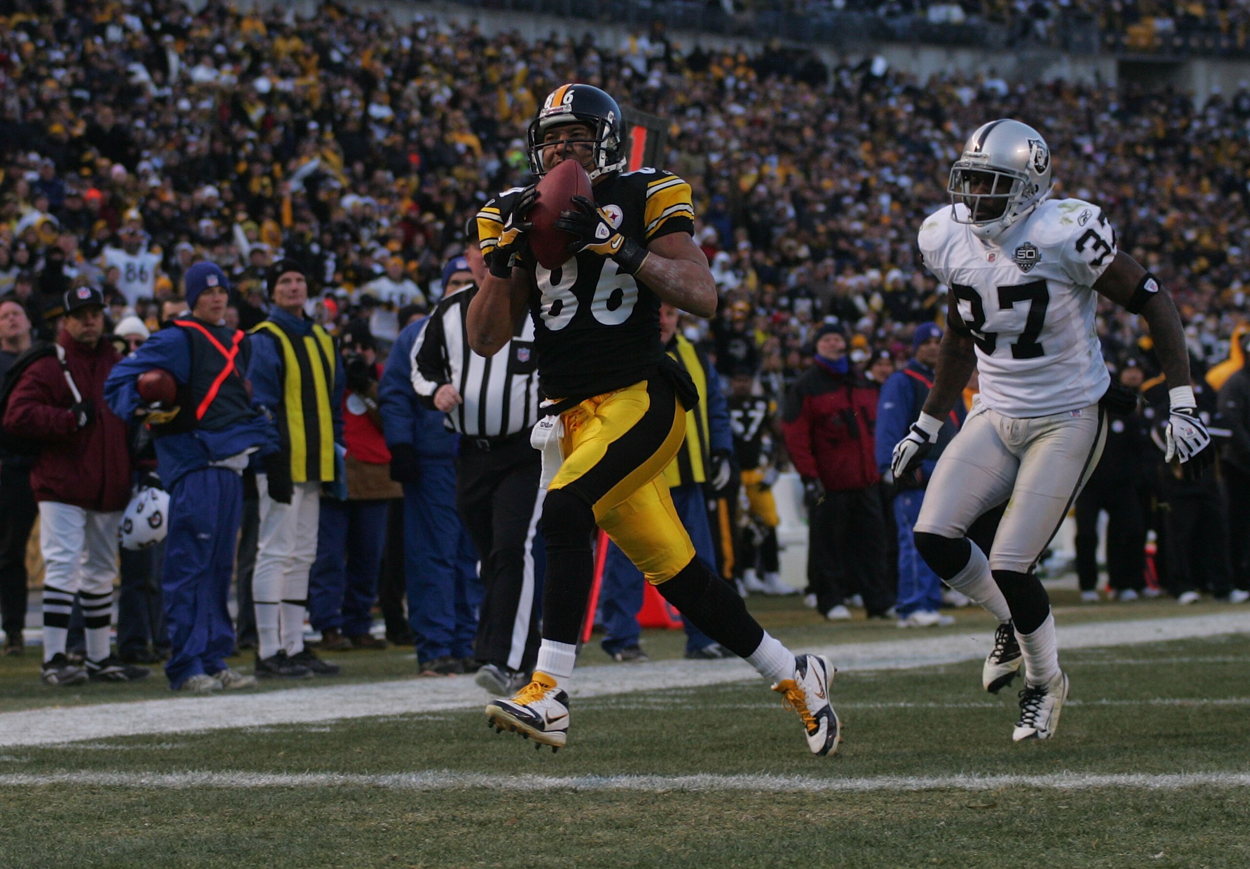 PITTSBURGH - DECEMBER 06: Hines Ward #86 of the Pittsburgh Steelers catches a touchdown pass in the fourth quarter in front of Chris Johnson #37 of the Oakland Raiders during the game on December 6, 2009 at Heinz Field in Pittsburgh, Pennsylvania. (Phot PITTSBURGH - DECEMBER 06: Hines Ward #86 of the Pittsburgh Steelers catches a touchdown pass in the fourth quarter in front of Chris Johnson #37 of the Oakland Raiders during the game on December 6, 2009 at Heinz Field in Pittsburgh, Pennsylvania. (Phot