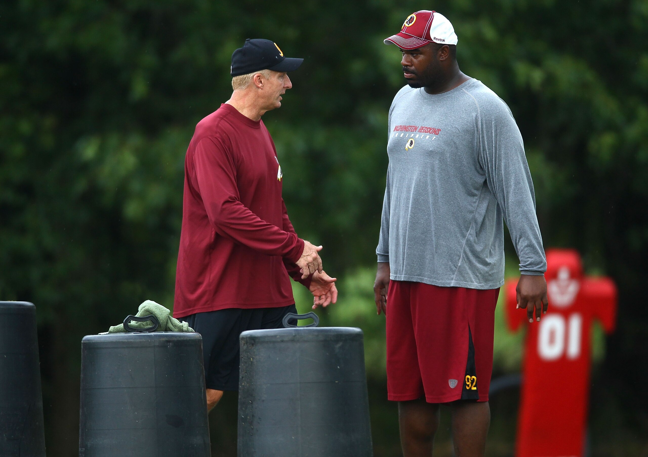 ASHBURN, VA - JULY 29:  Defensive lineman Albert Haynesworth #92 (R) works out with Defensive Coordinator Jim Haslett (L) after the Redskins first day of training camp on July 29, 2010 in Ashburn, Virginia.  (Photo by Win McNamee/Getty Images)