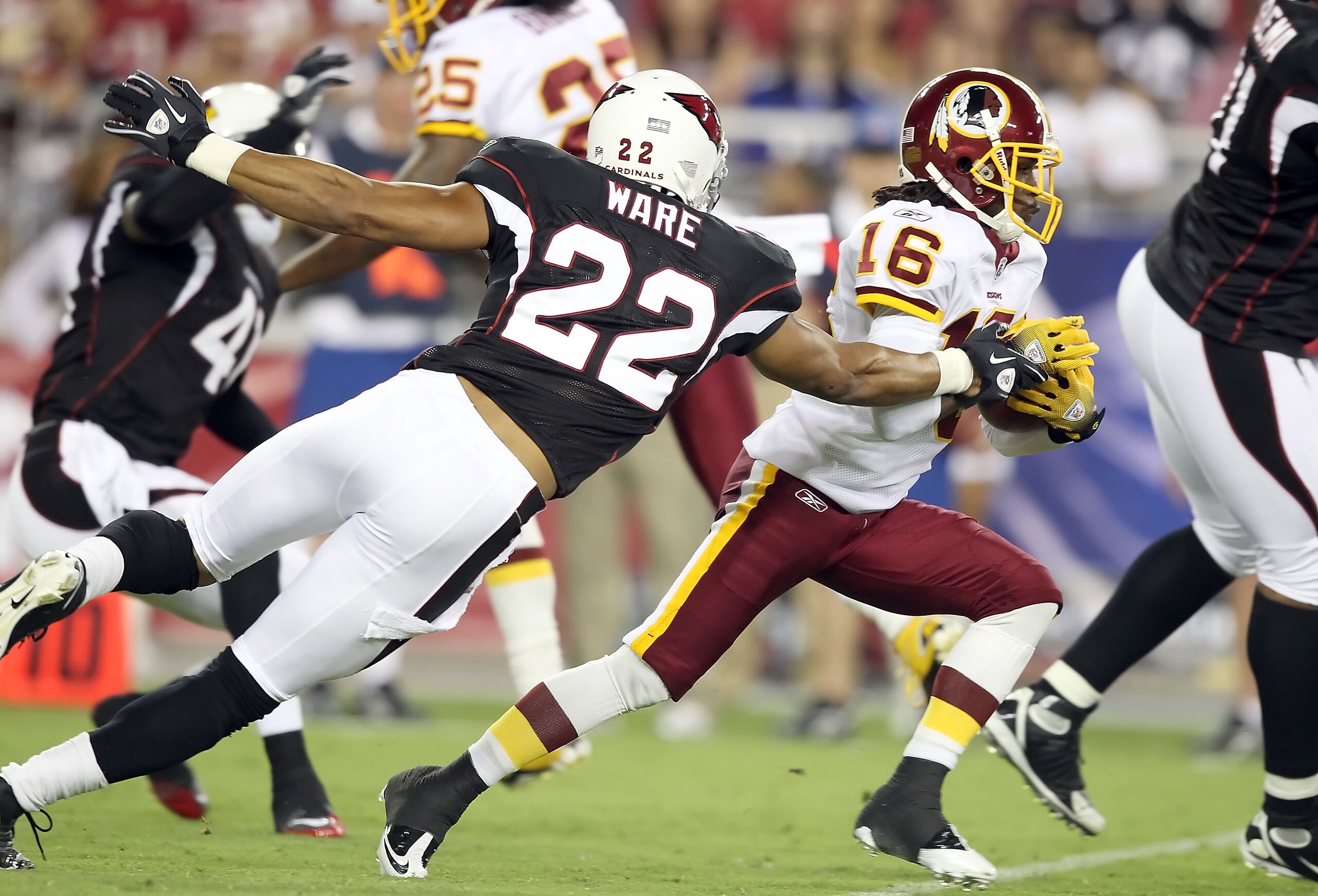 GLENDALE, AZ - SEPTEMBER 02:  Wide receiver Brandon Banks #16 of the Washington Redskins runs with the ball after a reception past Matt Ware #22 of the Arizona Cardinals during preseason NFL game at the University of Phoenix Stadium on September 2, 2010 i