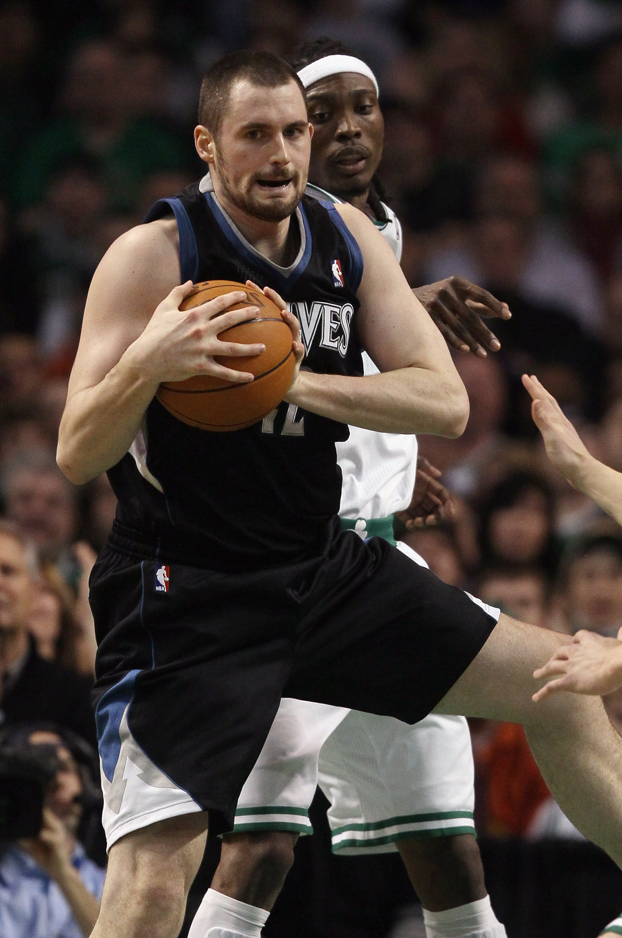 BOSTON, MA - JANUARY 03:  Kevin Love #42 of the Minnesota Timberwolves grabs the rebound before Marquis Daniels #8 of the Boston Celtics on January 3, 2011 at the TD Garden in Boston, Massachusetts. NOTE TO USER: User expressly acknowledges and agrees tha