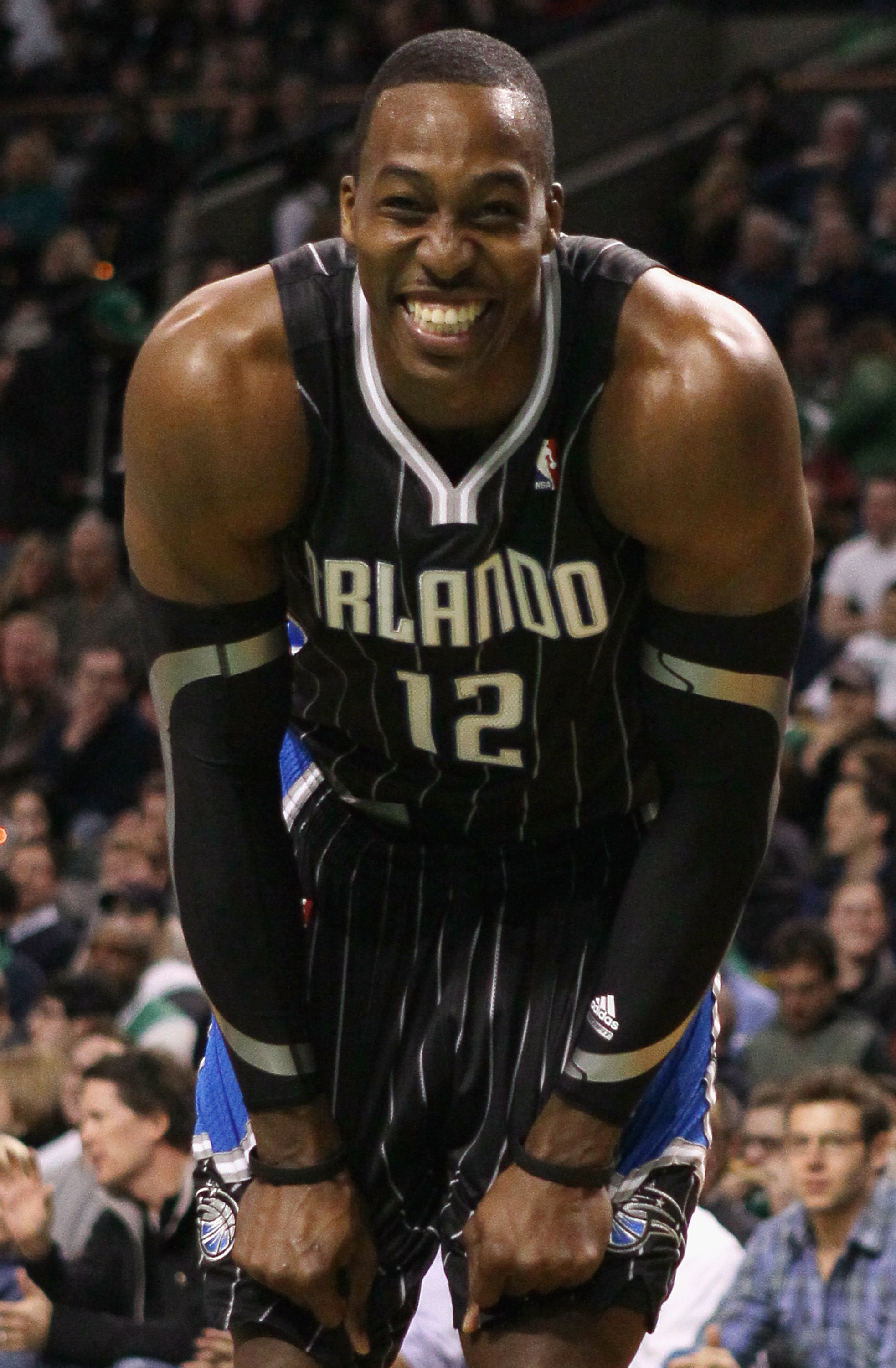 BOSTON, MA - JANUARY 17:  Dwight Howard #12 of the Orlando Magic smiles on the baseline as he waits for Shaquille O'Neal of the Boston Celtics to shoot a free throw on January 17, 2011 at the TD Garden in Boston, Massachusetts.  NOTE TO USER: User express
