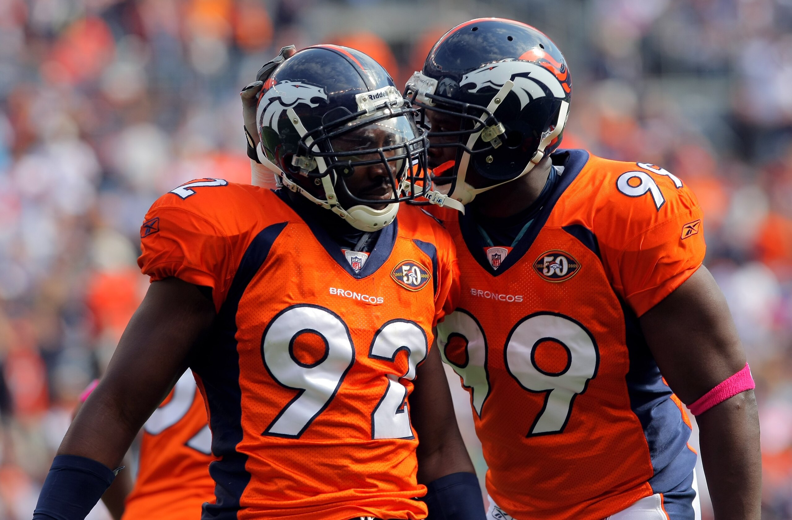 DENVER - OCTOBER 04:  Elivs Dumervil #92 of the Denver Broncos celebrates with Vonnie Holliday #99 as they defend against the Dallas Cowboys during NFL action at Invesco Field at Mile High on October 4, 2009 in Denver, Colorado. The Broncos defeated the C