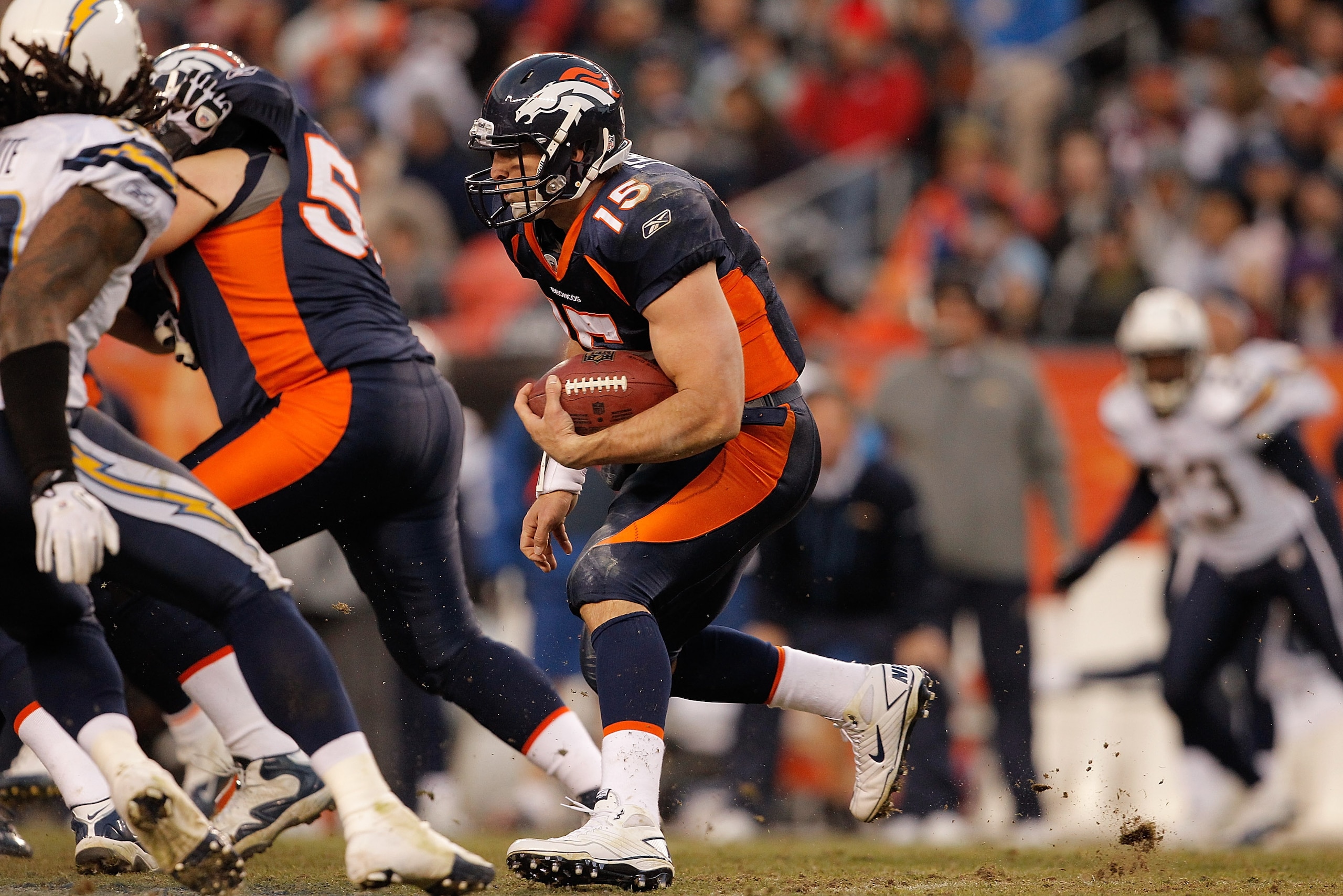 DENVER, CO - JANUARY 2:  Quarterback Tim Tebow #15 of the Denver Broncos looks for a hole in the line of the San Diego Chargers' defense during the fourth quarter at INVESCO Field at Mile High on January 2, 2011 in Denver, Colorado. (Photo by Justin Edmon