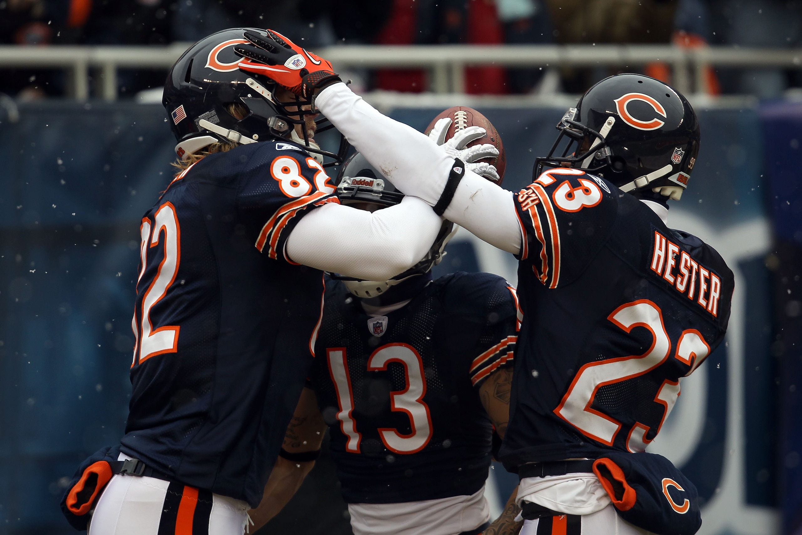 CHICAGO, IL - JANUARY 16:  Tight end Greg Olsen #82 of the Chicago Bears celebrates with Johnny Knox #13 and Devin Hester #23 after Olsen scores on a 58-yard touchdown reception in the first quarter against the Seattle Seahawks in the 2011 NFC divisional