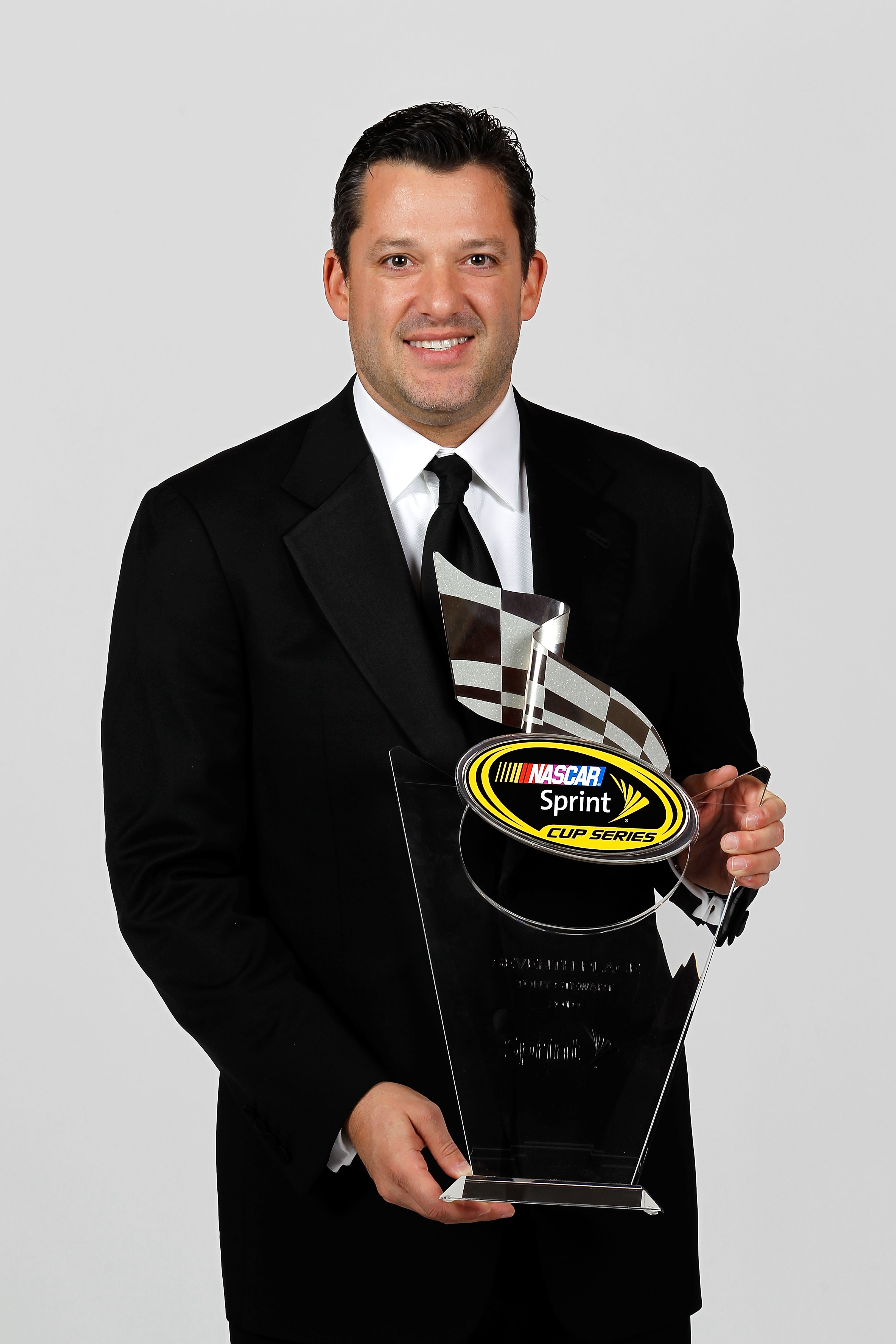 LAS VEGAS, NV - DECEMBER 03:  NASCAR driver Tony Stewart poses with his seventh place trophy during the NASCAR Sprint Cup Series awards banquet at the Wynn Las Vegas Hotel on December 3, 2010 in Las Vegas, Nevada.  (Photo by Todd Warshaw/Getty Images for