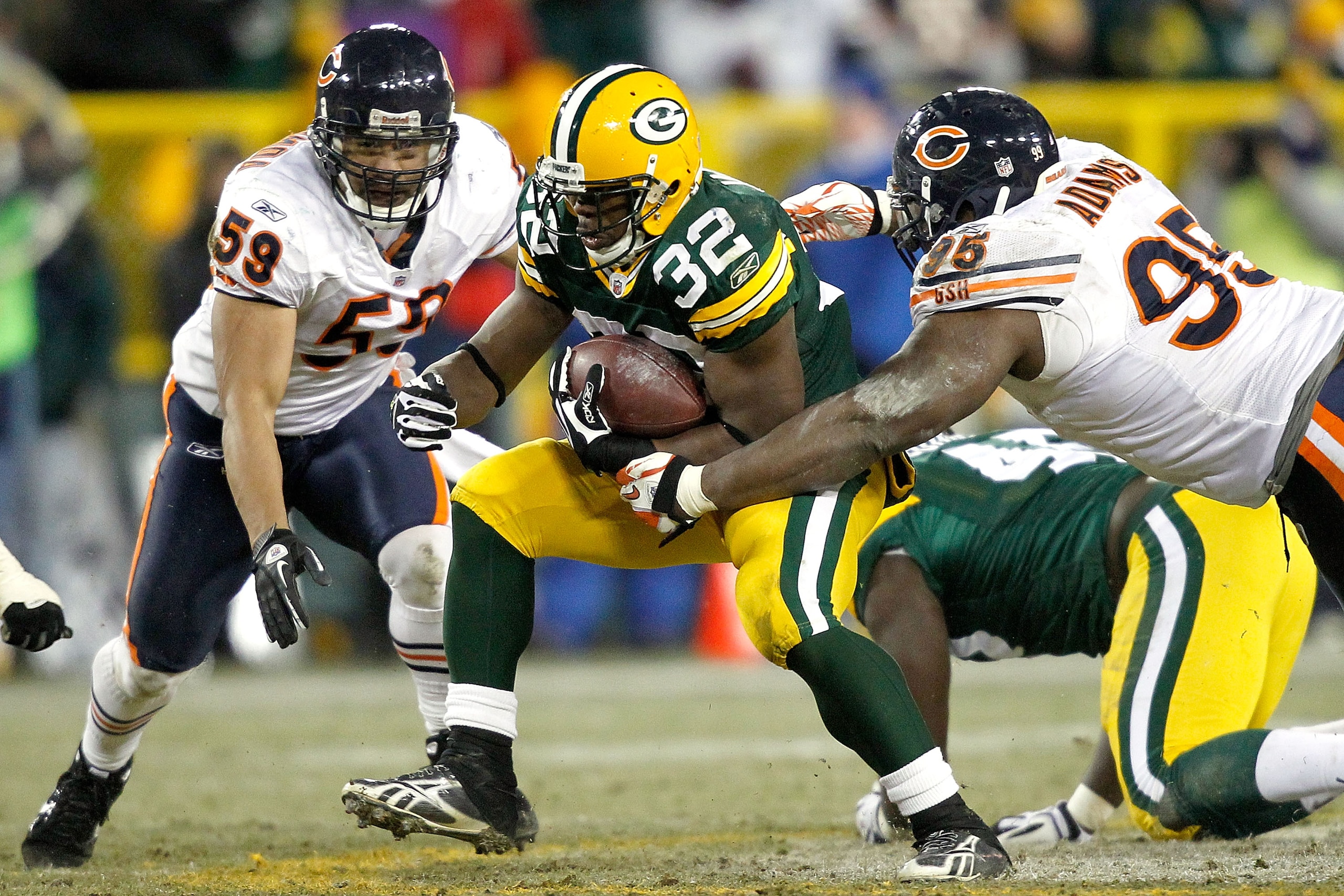 GREEN BAY, WI - JANUARY 02: Kahlil Bell #32 of the Green Bay Packers carries the ball against Pisa Tinoisamoa #59 and Anthony Adams #95 of the Chicago Bears at Lambeau Field on January 2, 2011 in Green Bay, Wisconsin. (Photo by Matthew Stockman/Getty Im GREEN BAY, WI - JANUARY 02: Kahlil Bell #32 of the Green Bay Packers carries the ball against Pisa Tinoisamoa #59 and Anthony Adams #95 of the Chicago Bears at Lambeau Field on January 2, 2011 in Green Bay, Wisconsin. (Photo by Matthew Stockman/Getty Im