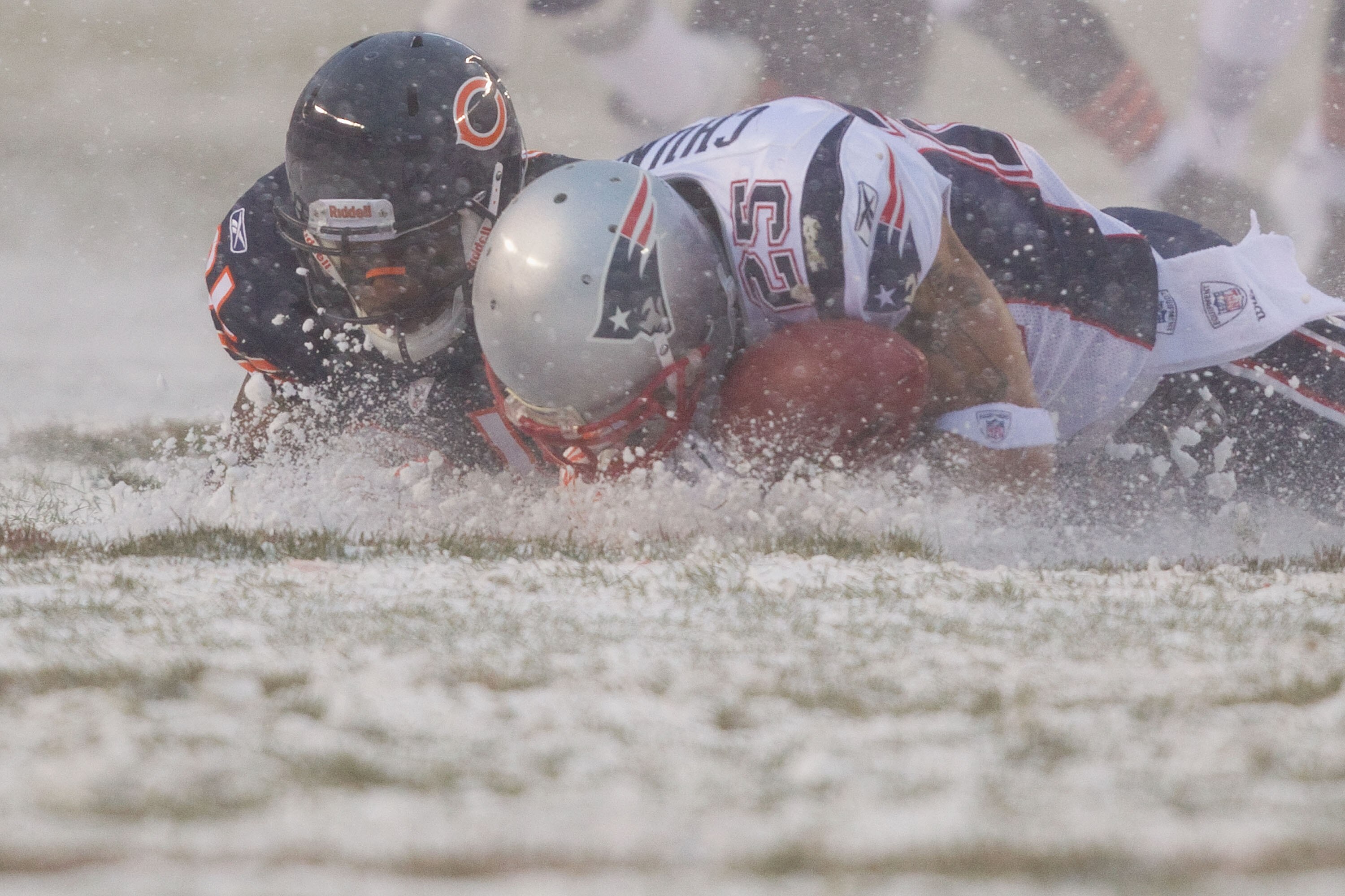 CHICAGO, IL - DECEMBER 12: Pat Chung #25 of the New England Patriots looks to recover a fumble Corey Graham #21 of the Chicago Bears at Soldier Field on December 12, 2010 in Chicago, Illinois.  The Patriots beat the Bears 36-7.  (Photo by Dilip Vishwanat/